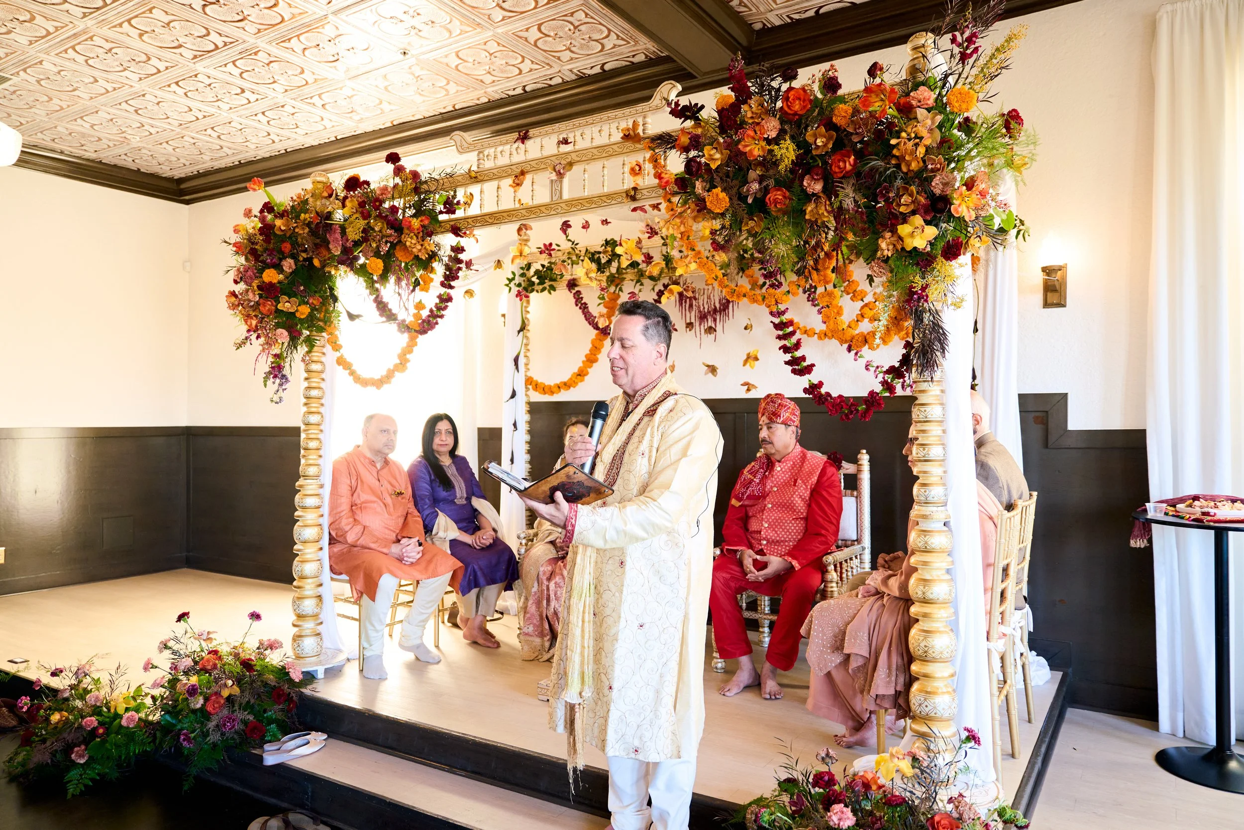 The four pillars of the mandap framing the couple's ceremony