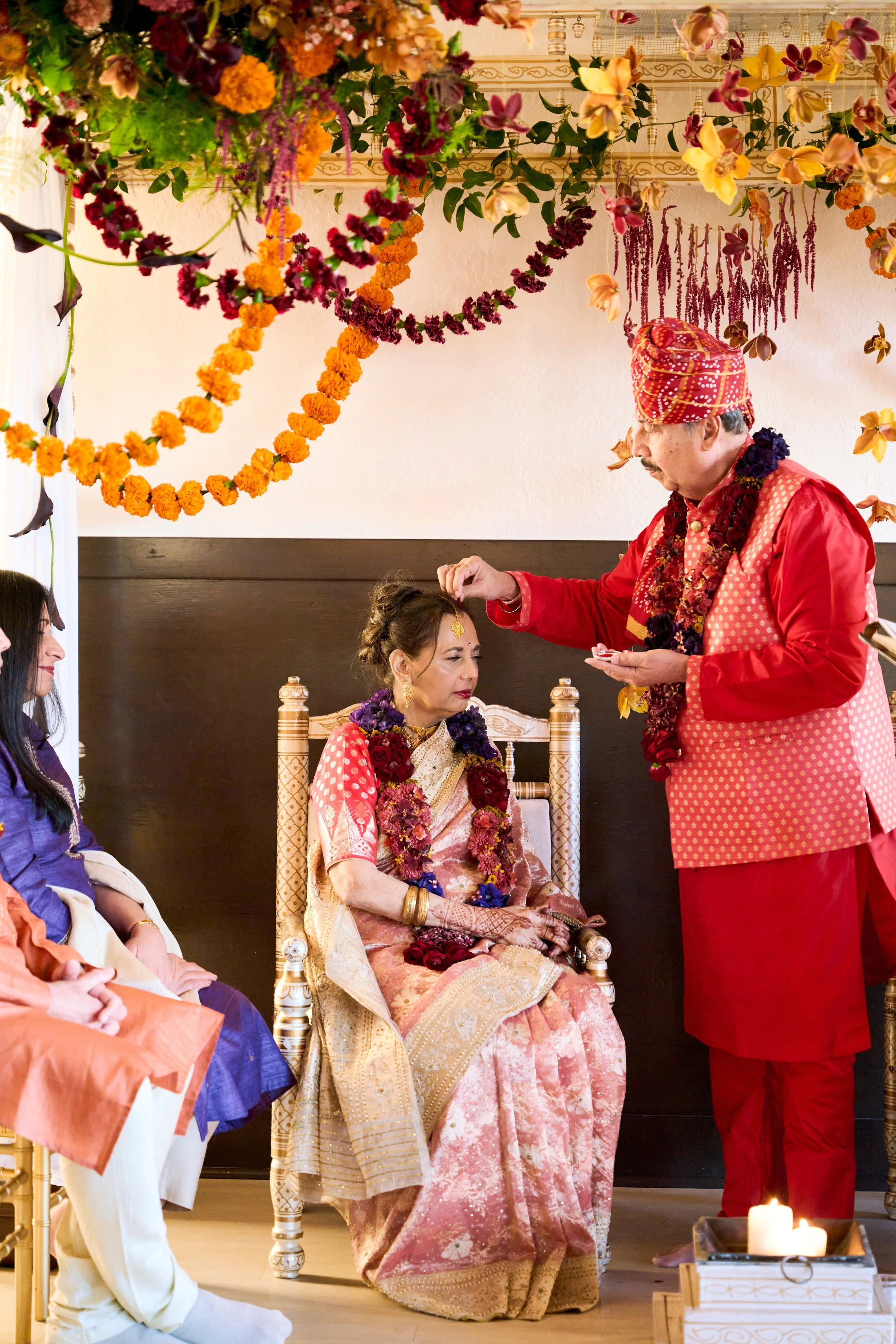 Guests watching the ceremony unfold under the mandap