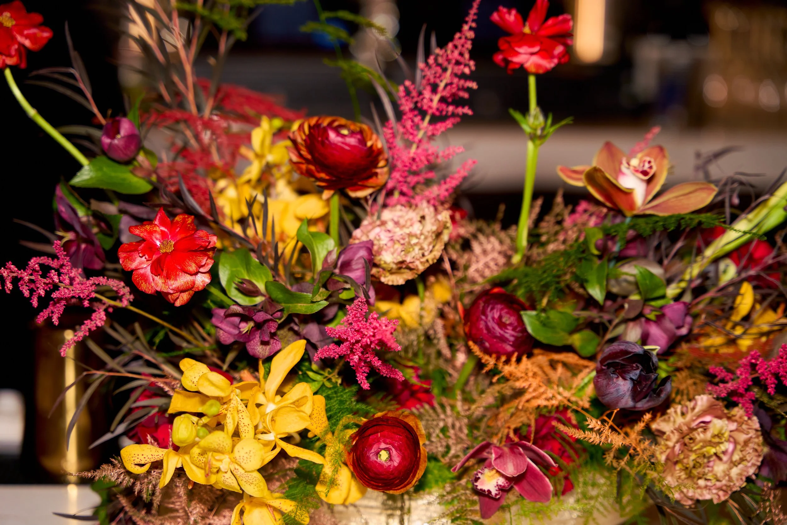 Moody Indian wedding tablescape in deepened reds and golds