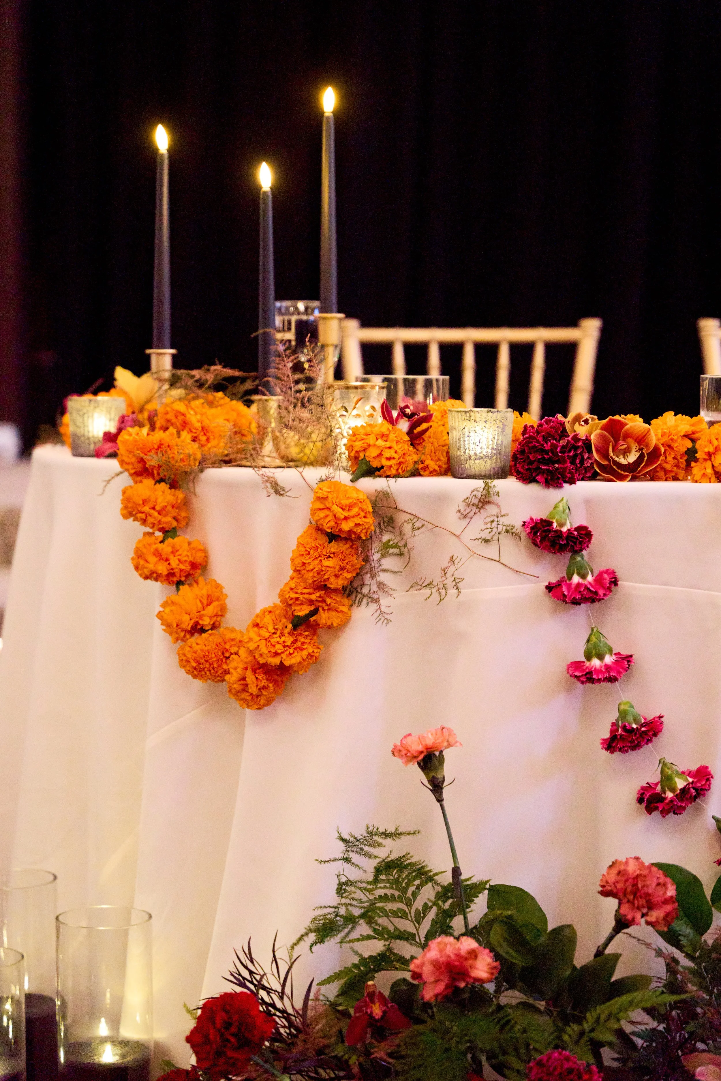 Marigold and candle decor at a Hindu wedding reception