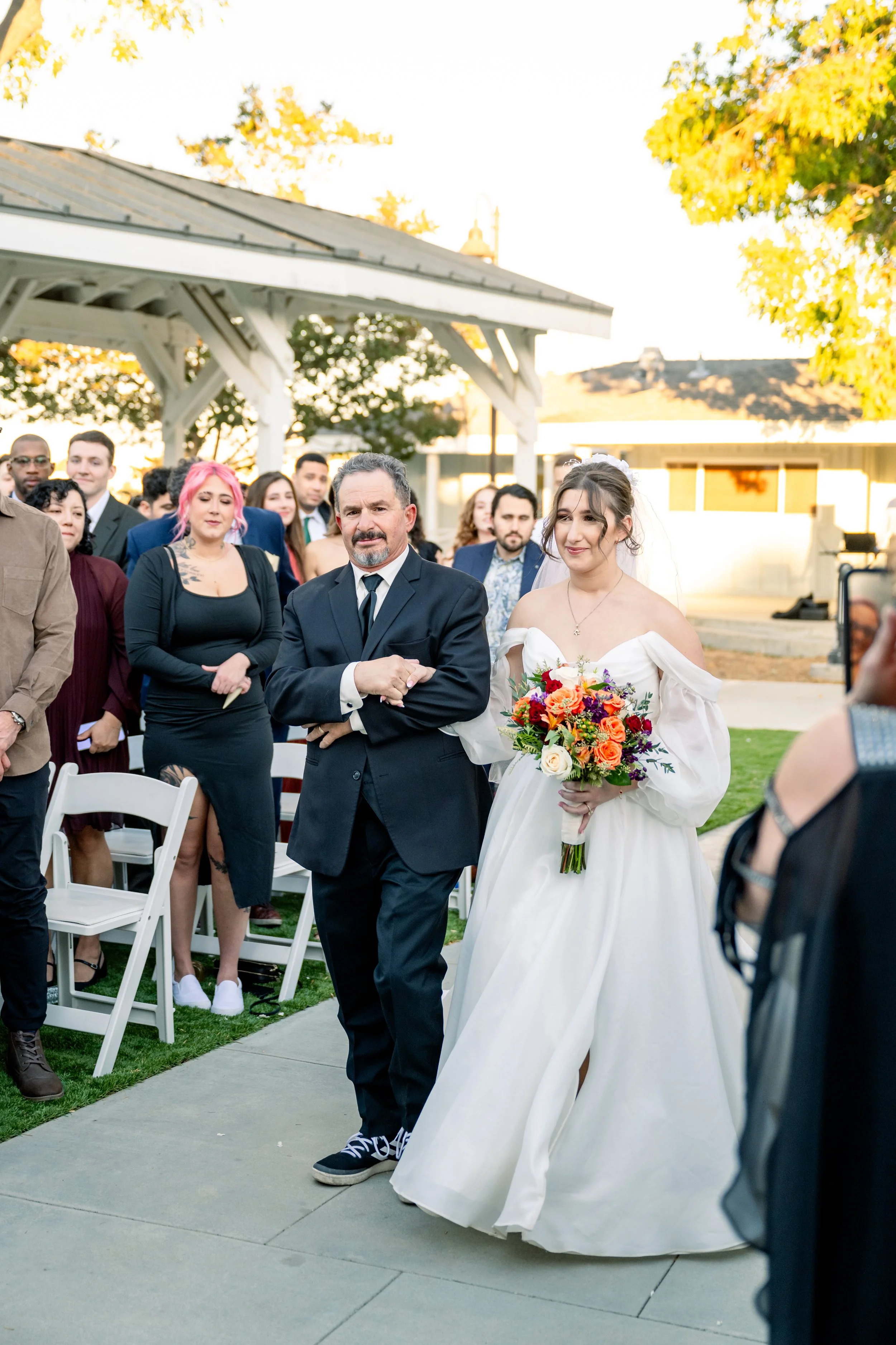 Candid of the bride and her father walking down the aisle