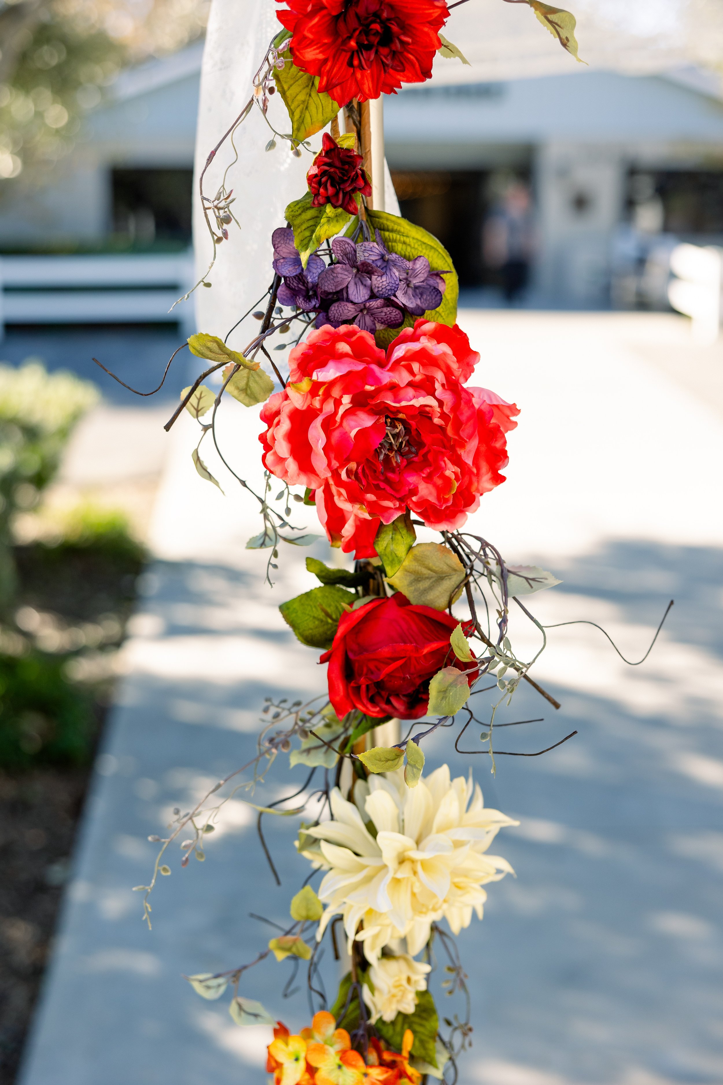 Ceremony arch dressed in fall wedding florals