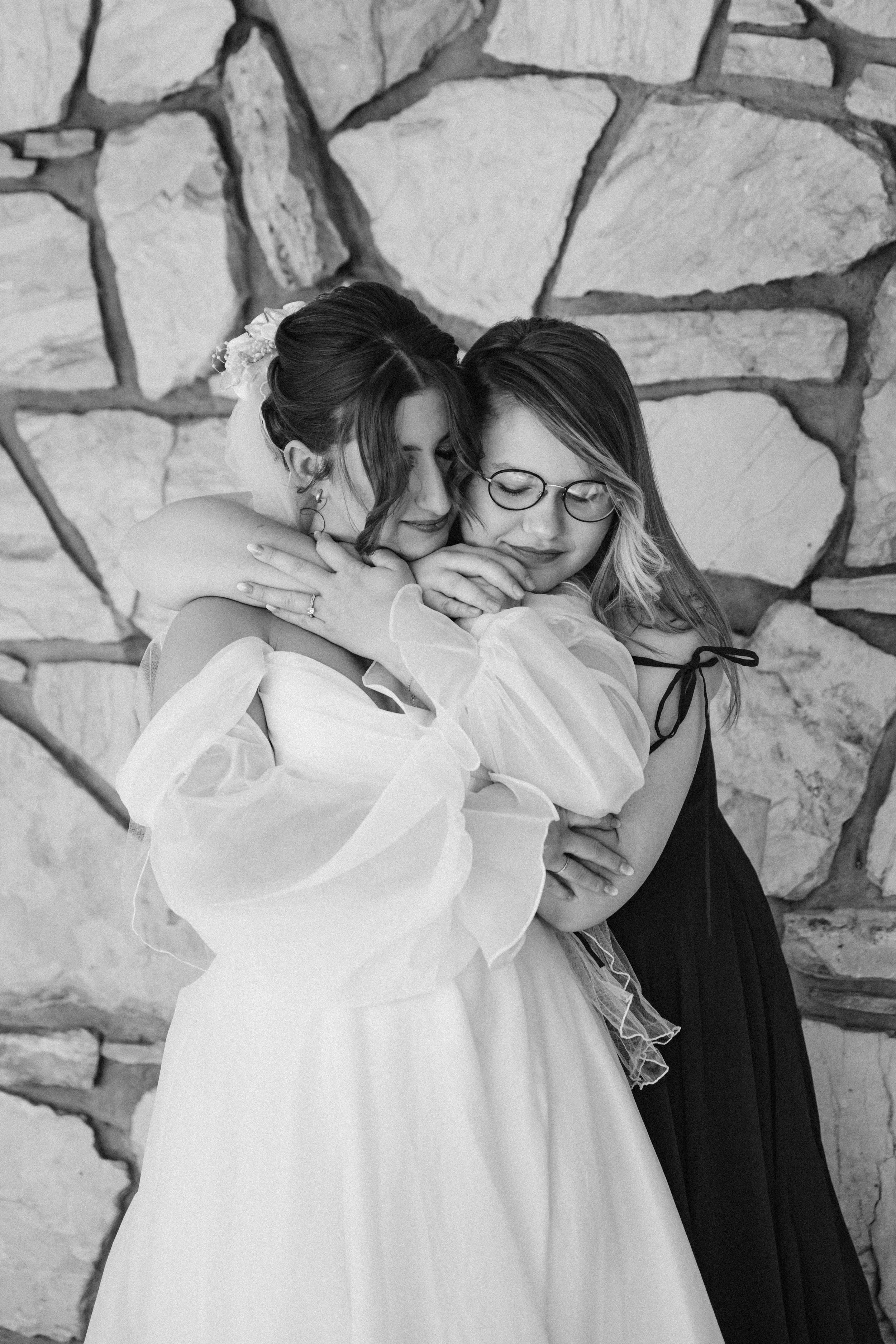 candid moment of bride and mother hugging before ceremony
