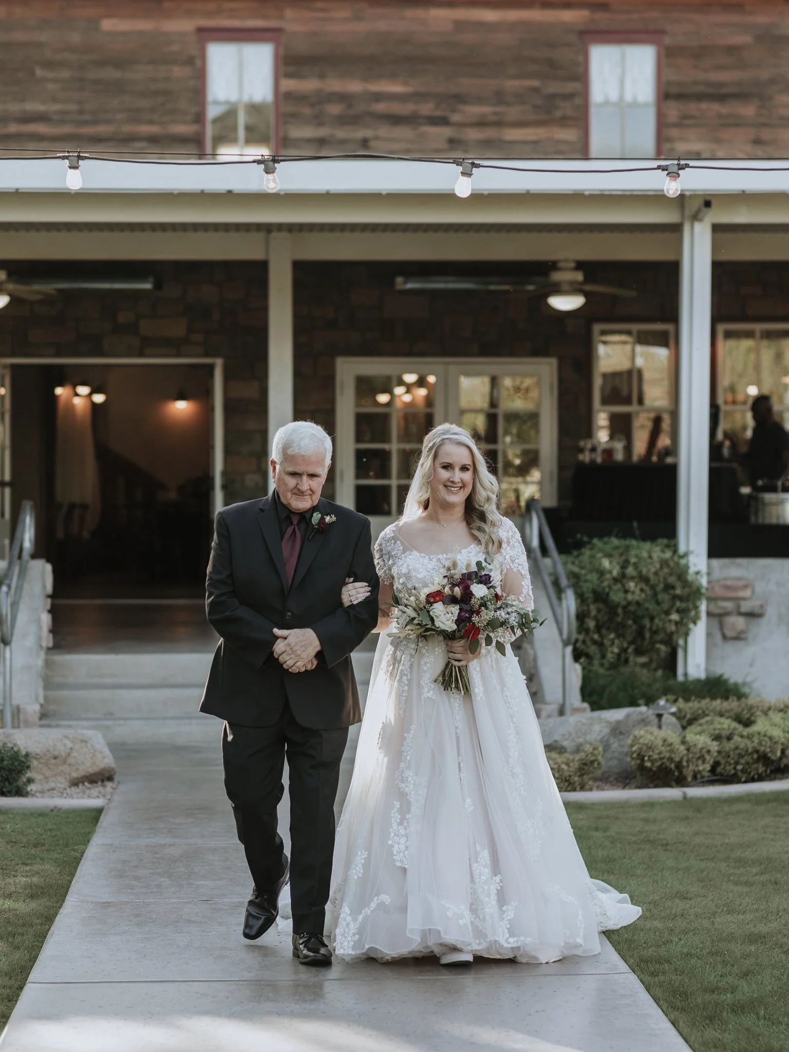 Bride walks the aisle with her father at Shenandoah Mill in Gilbert, Arizona