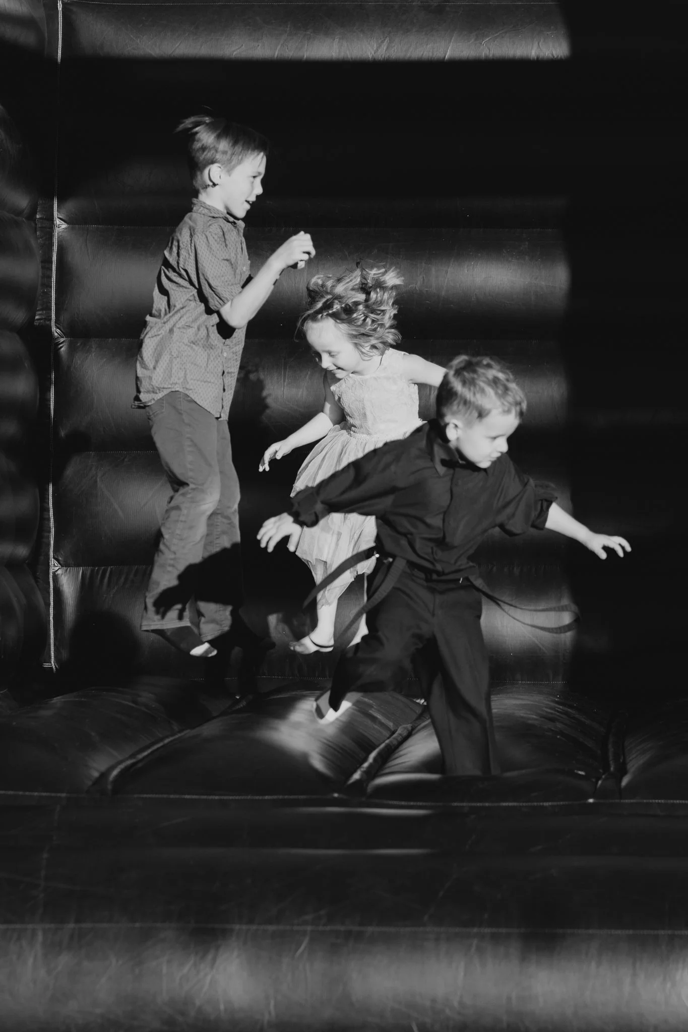 Guests enjoy bounce house at a Shenandoah Mill fall wedding