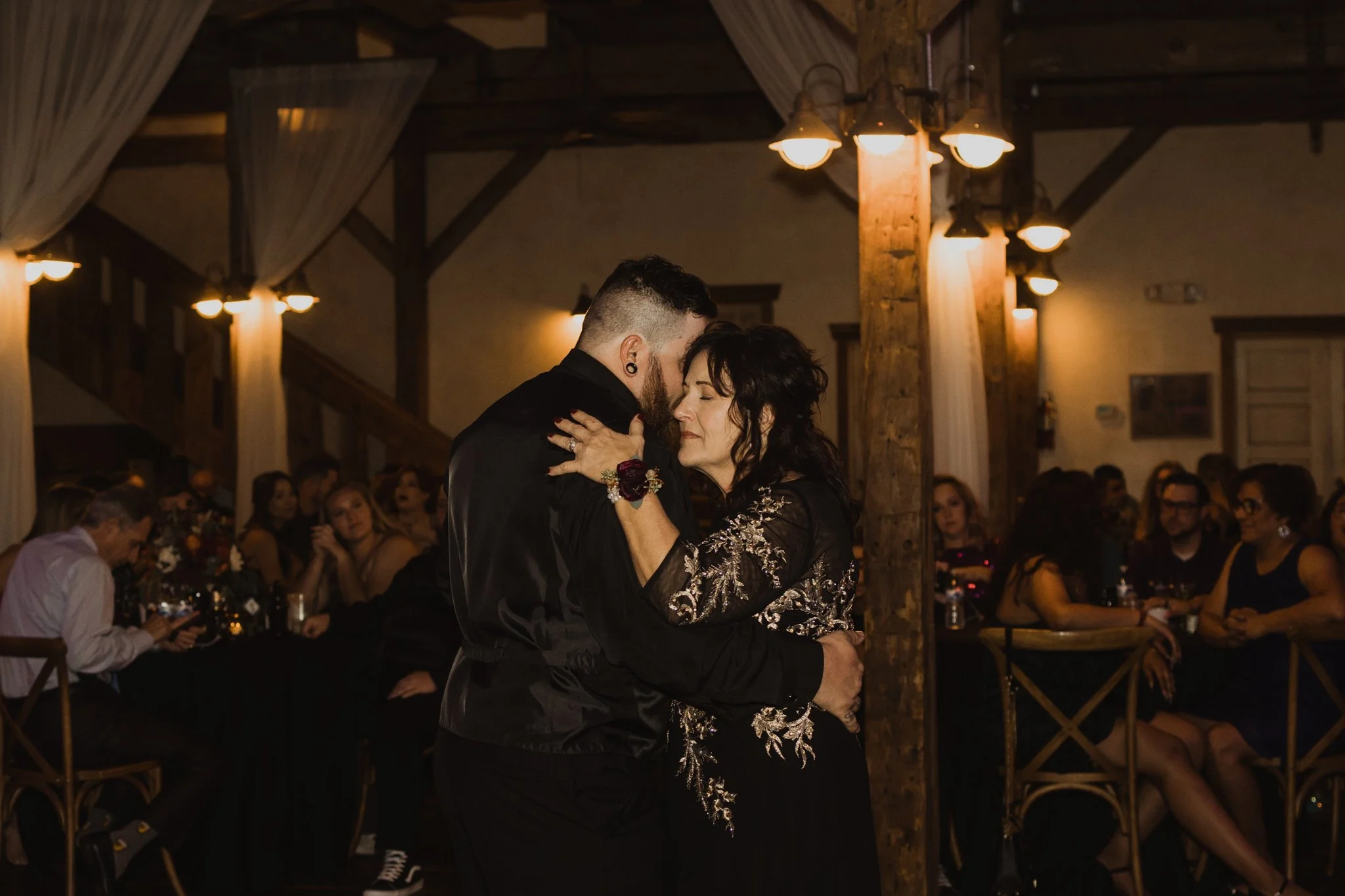 Mother and son share a dance at a fall wedding reception at Shenandoah Mill