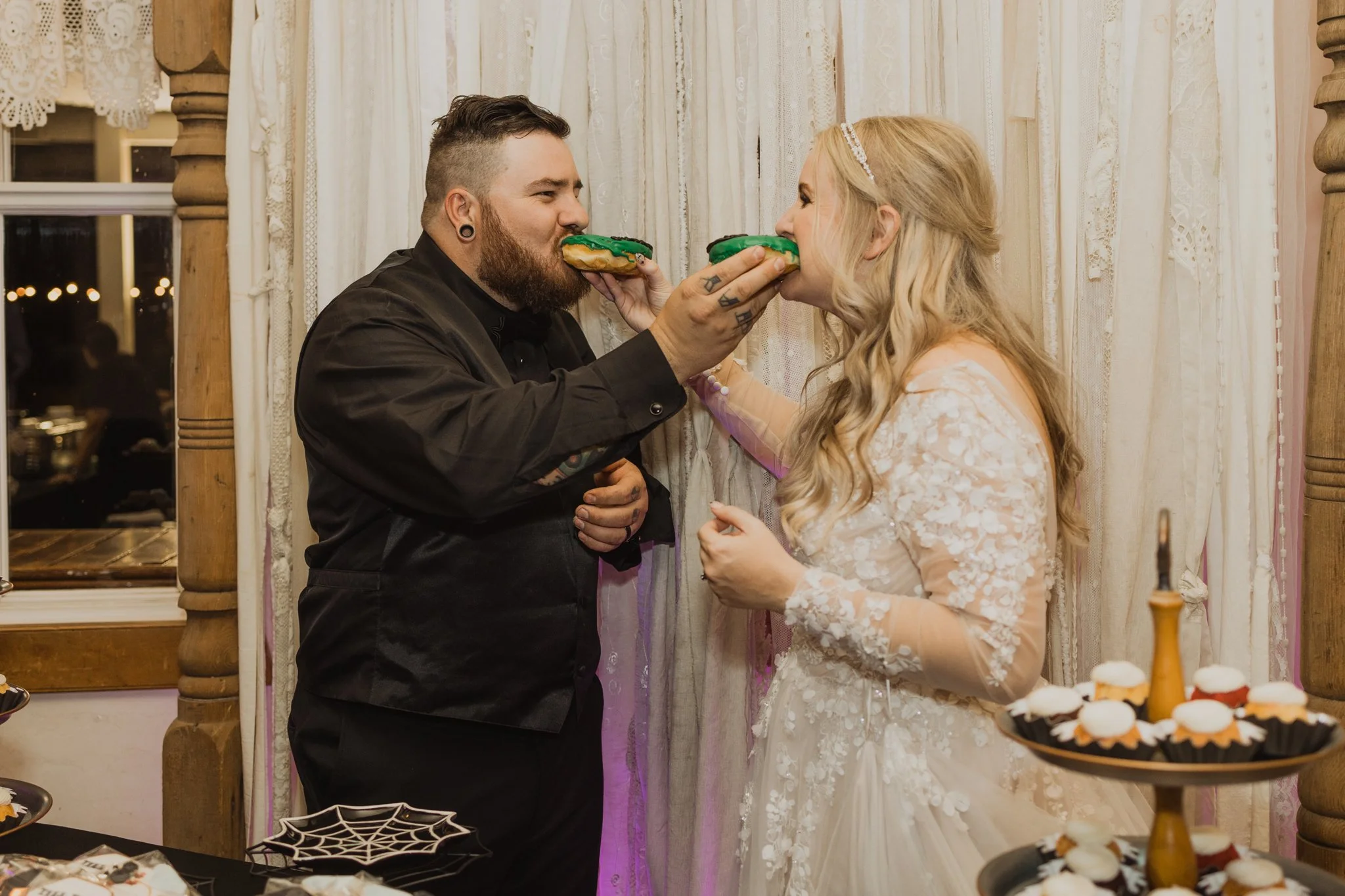 Green Halloween donuts served instead of cake at a dark and moody wedding