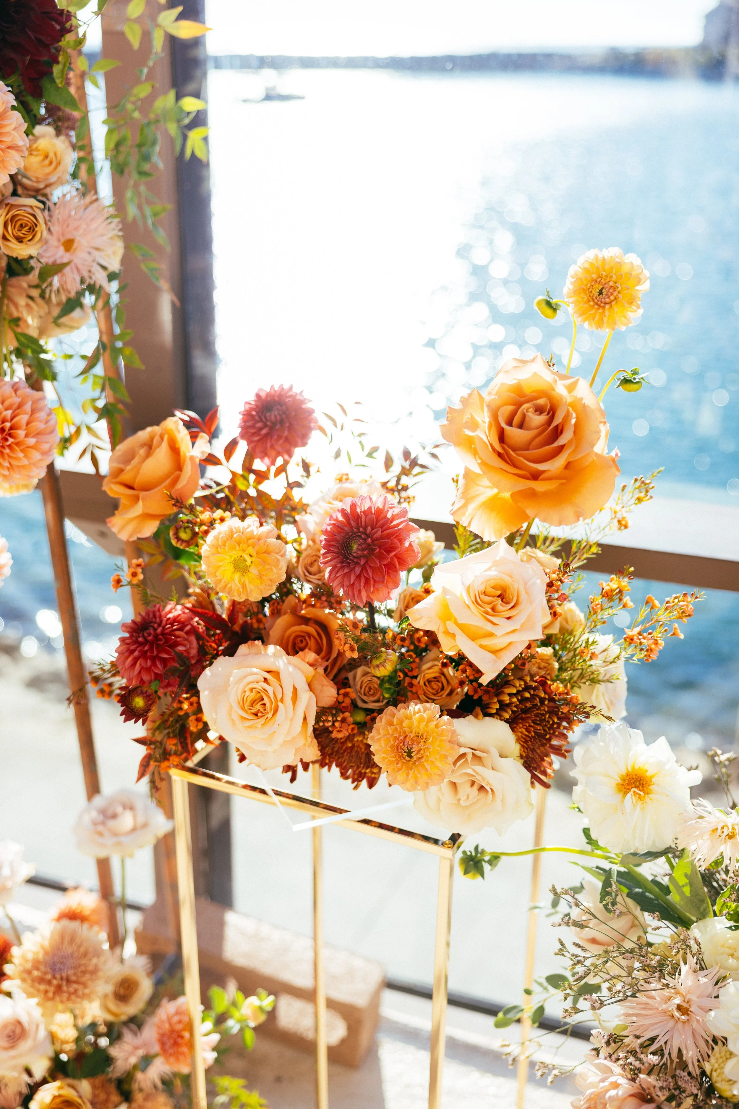 Autumn roses and dahlias on a gold stand overlooking Dana Point Harbor