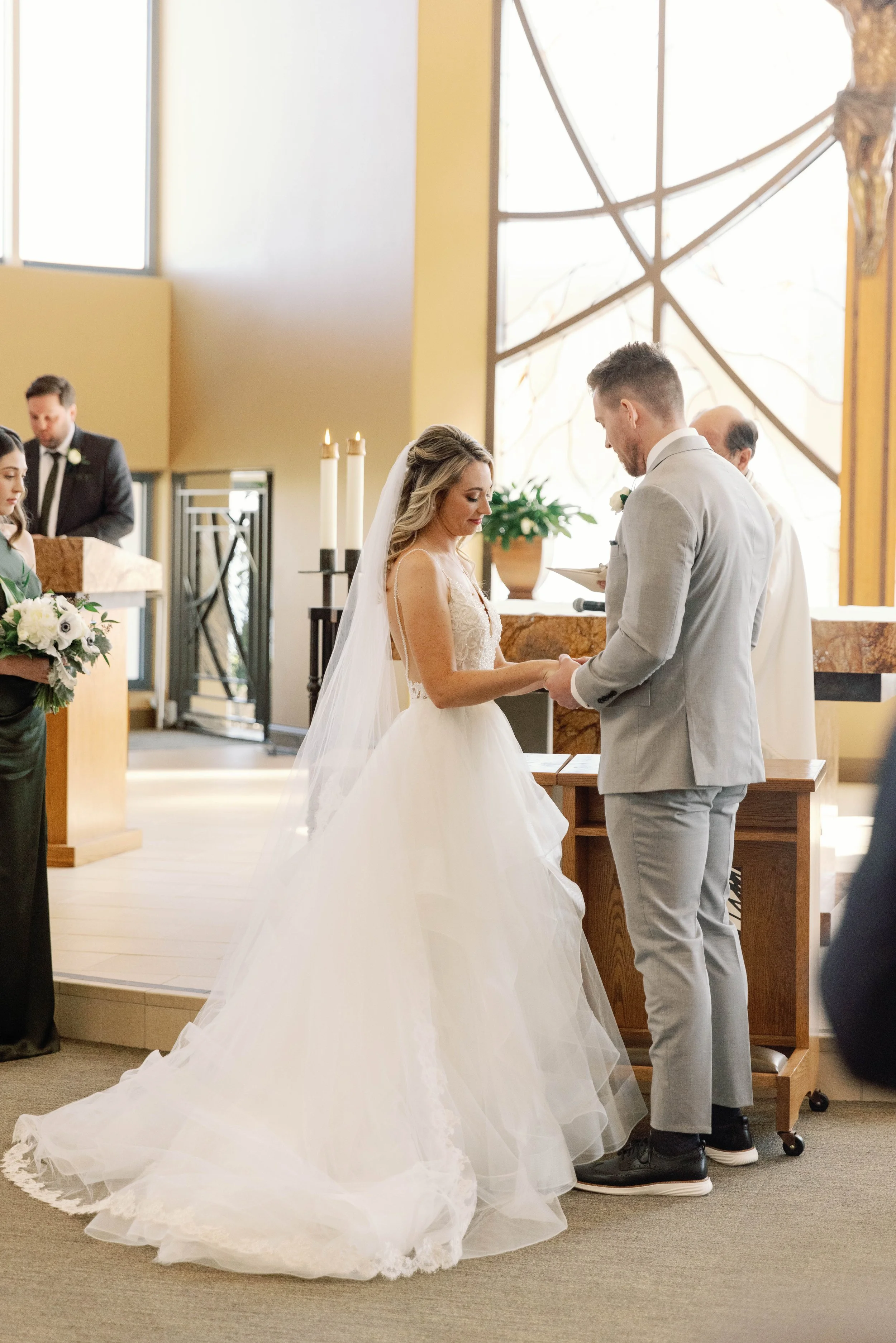 Bride and groom exchange vows at a church ceremony before their Dana Point reception