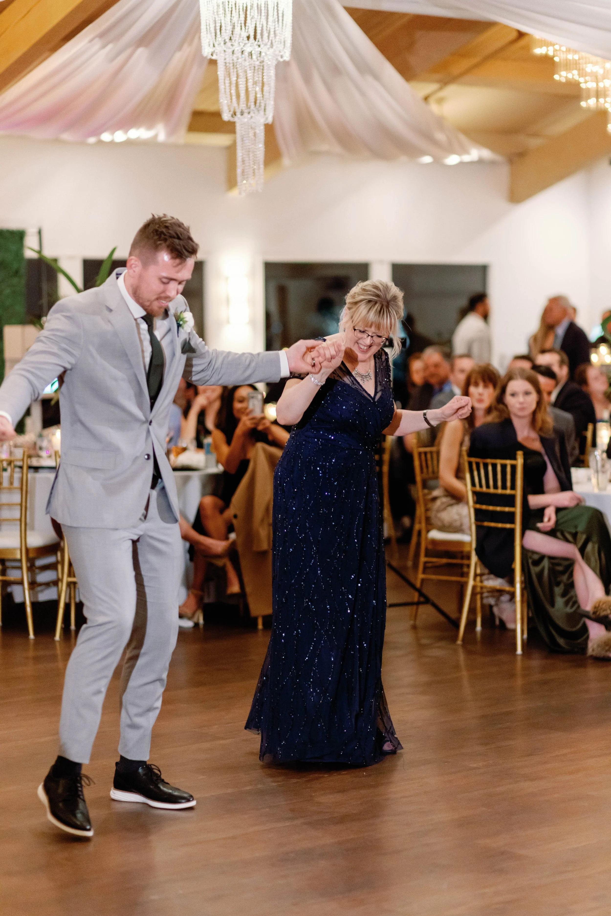 Groom dances with his mother at a Dana Point Yacht Club wedding reception