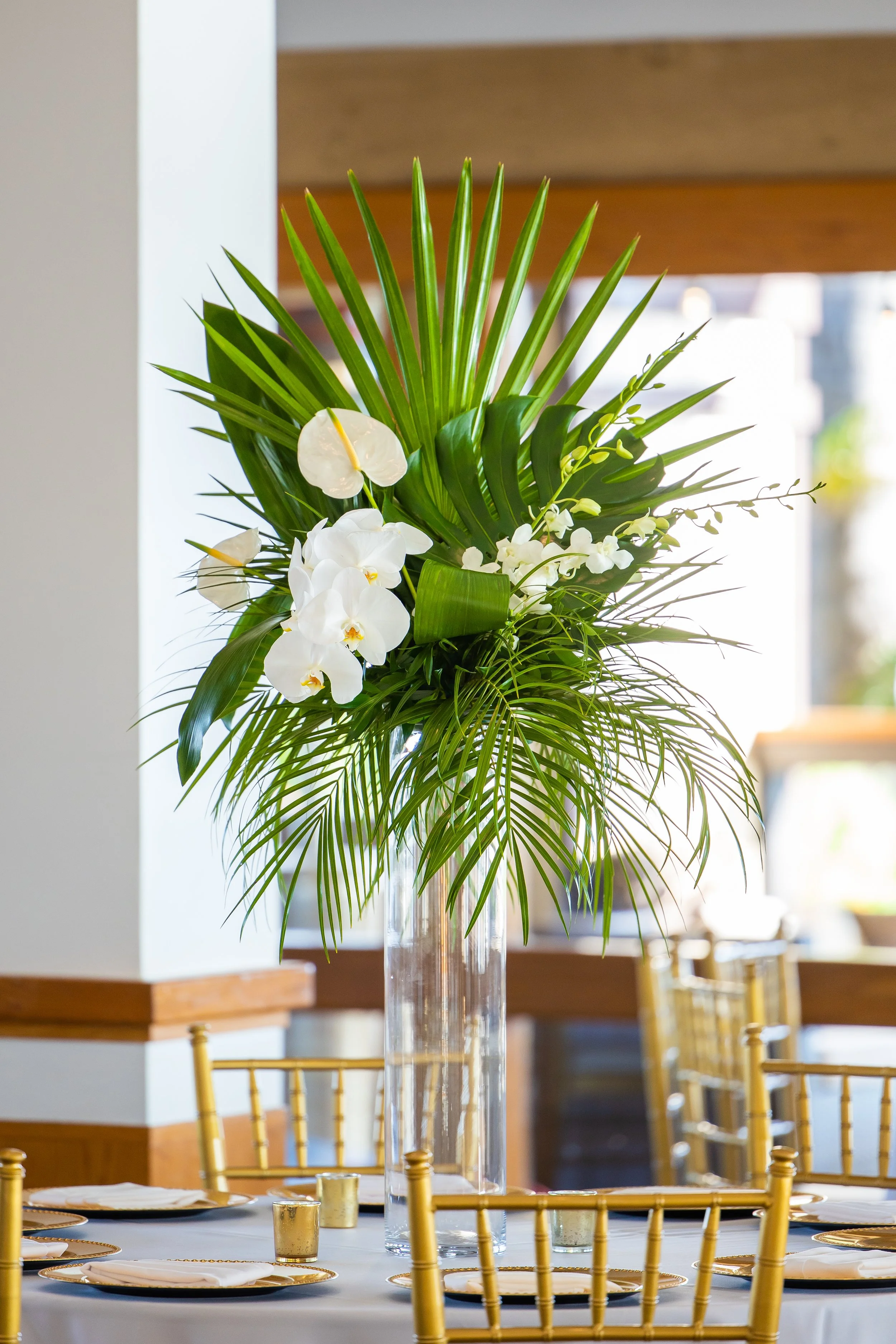 Tall tropical palm and orchid centerpiece at a Dana Point Yacht Club reception