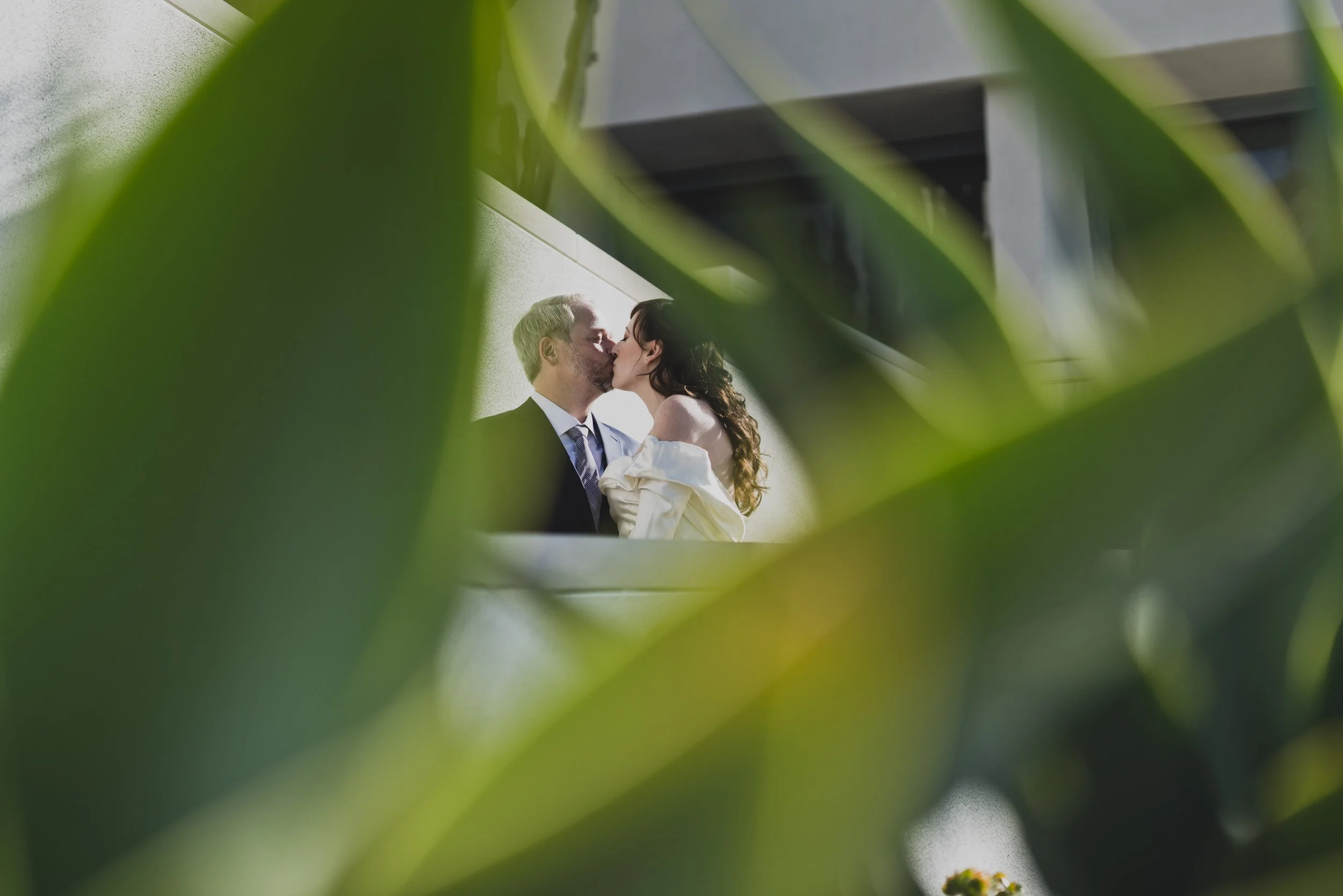 Bride and groom sharing a quiet kiss during portraits at their luxury destination wedding.