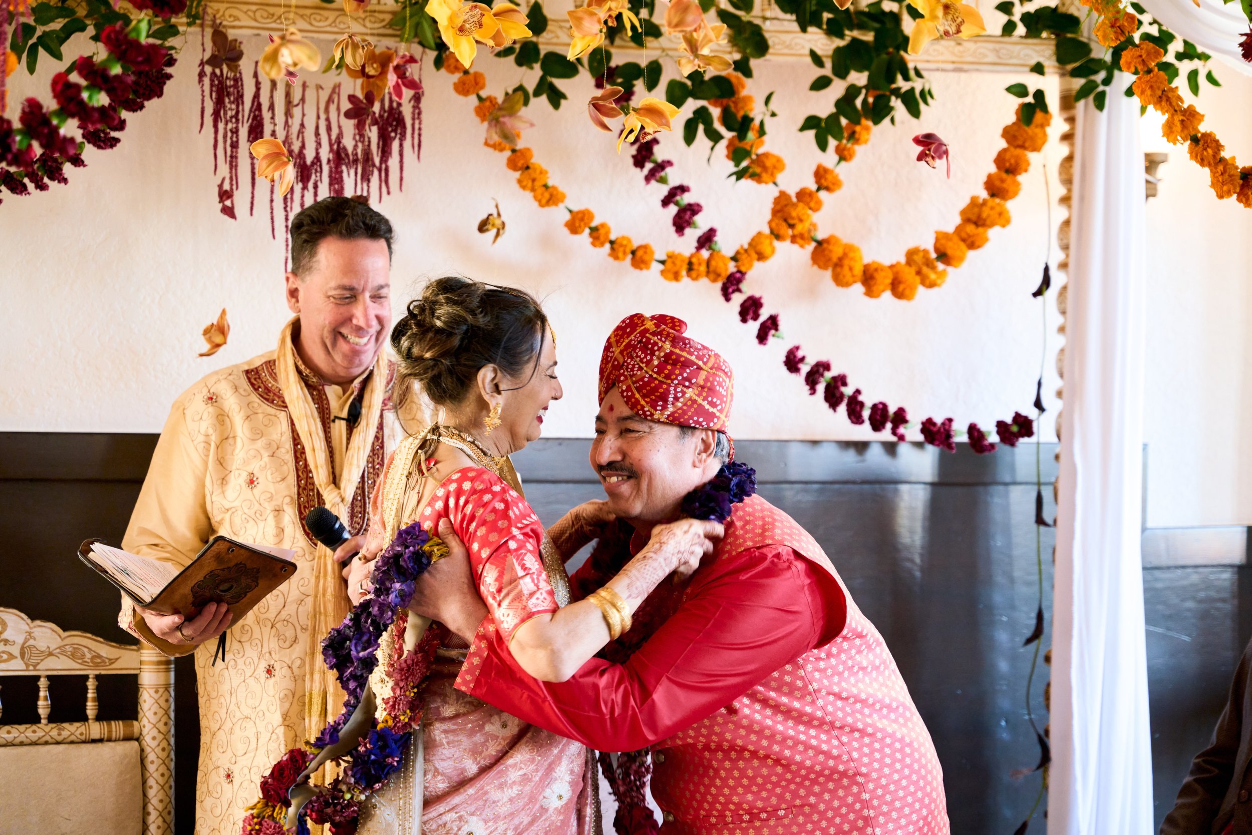 The couple exchange flower garlands during the jai mala