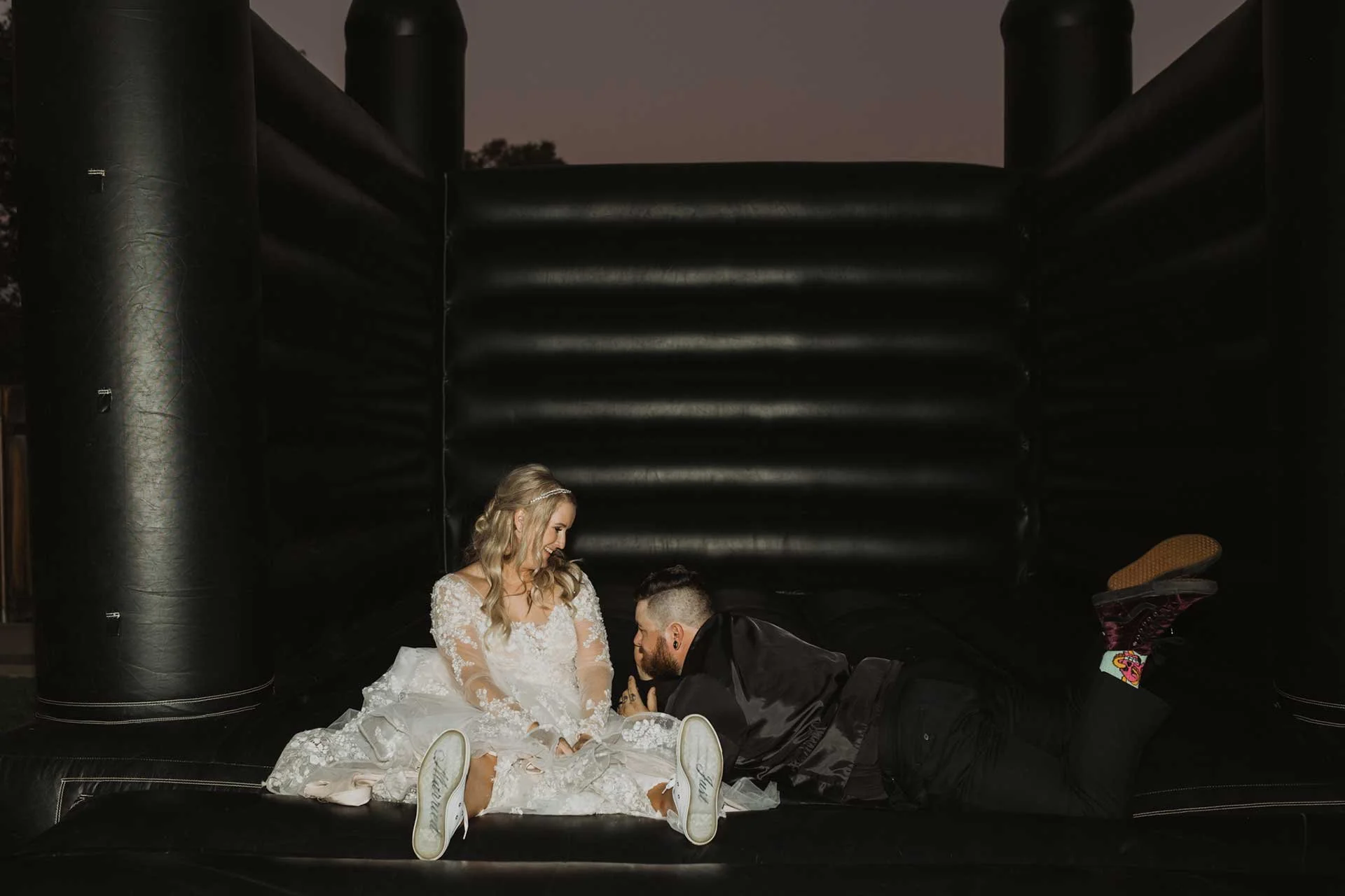 alternative wedding couple in a black bounce house