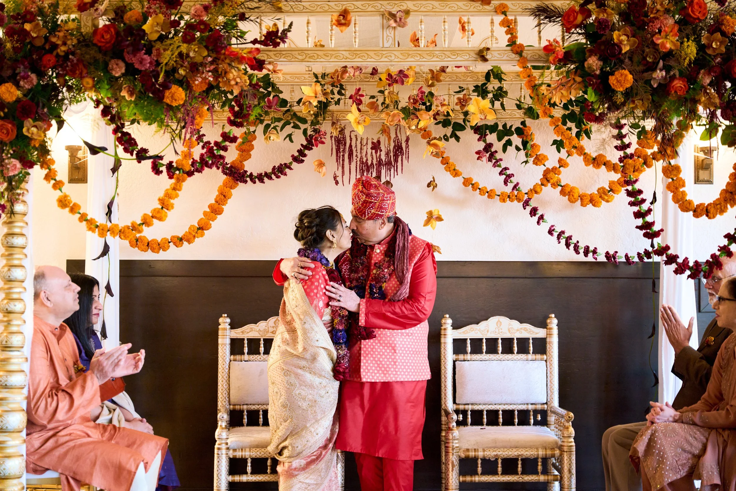 Couple standing under the mandap during their Hindu wedding ceremony