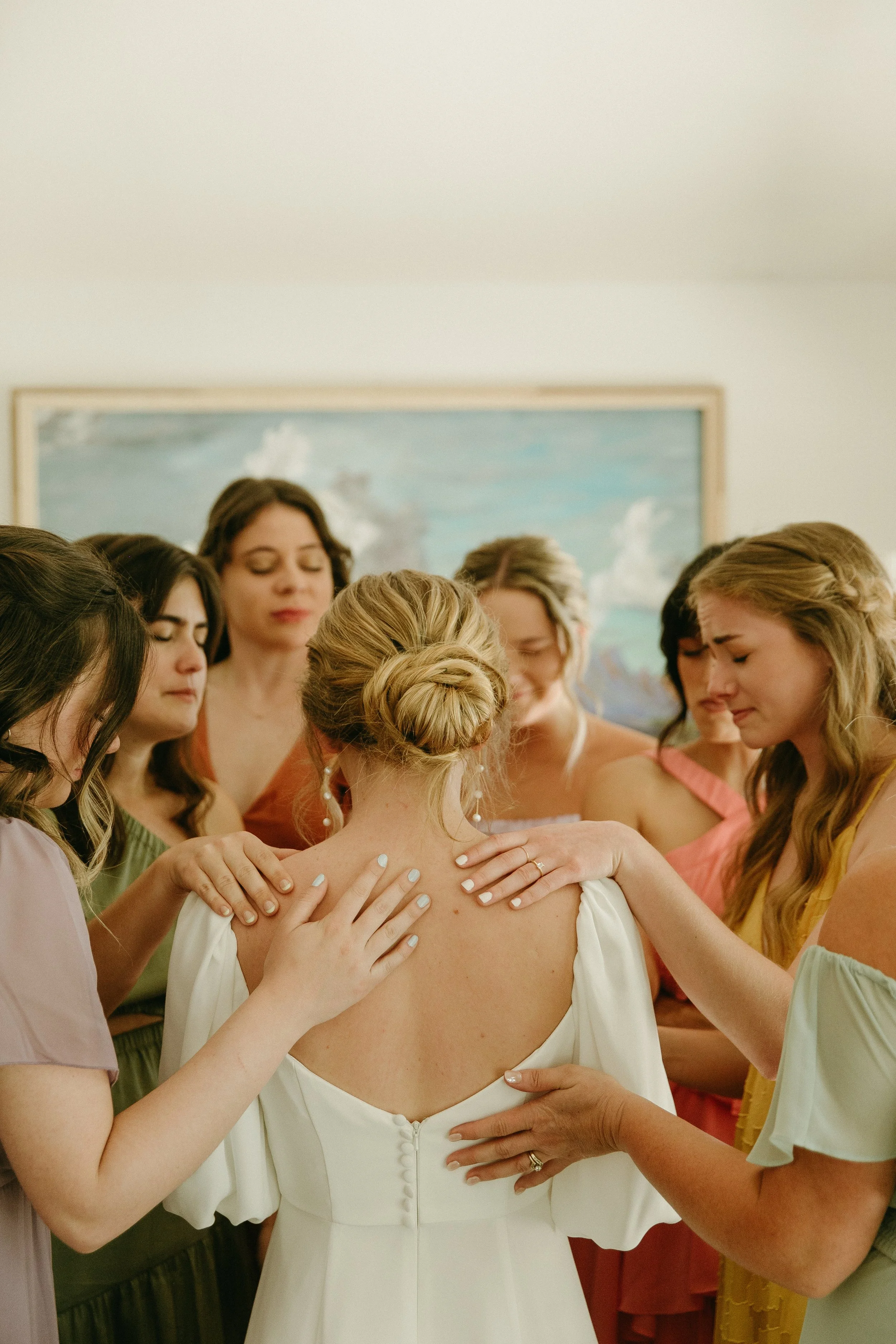 utah wedding party praying over the bride on her wedding day
