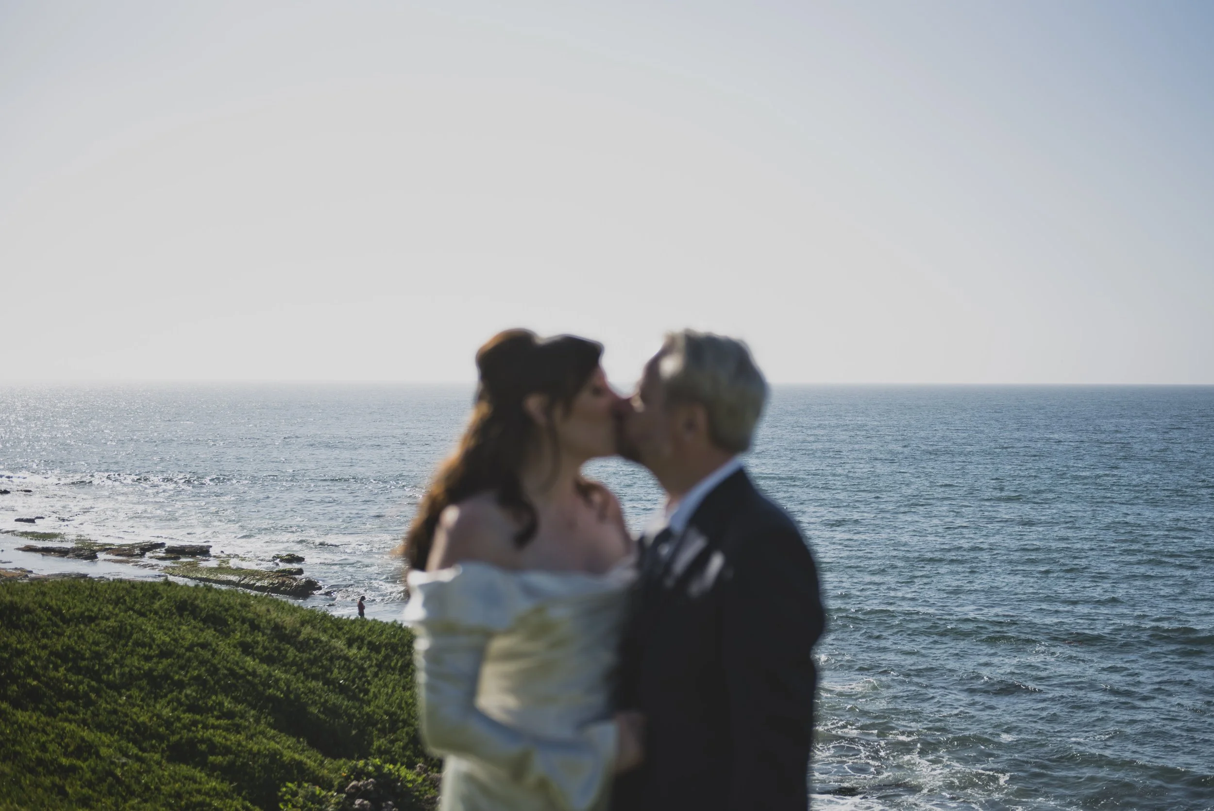 Bride and groom sharing a quiet kiss during portraits at their luxury destination wedding