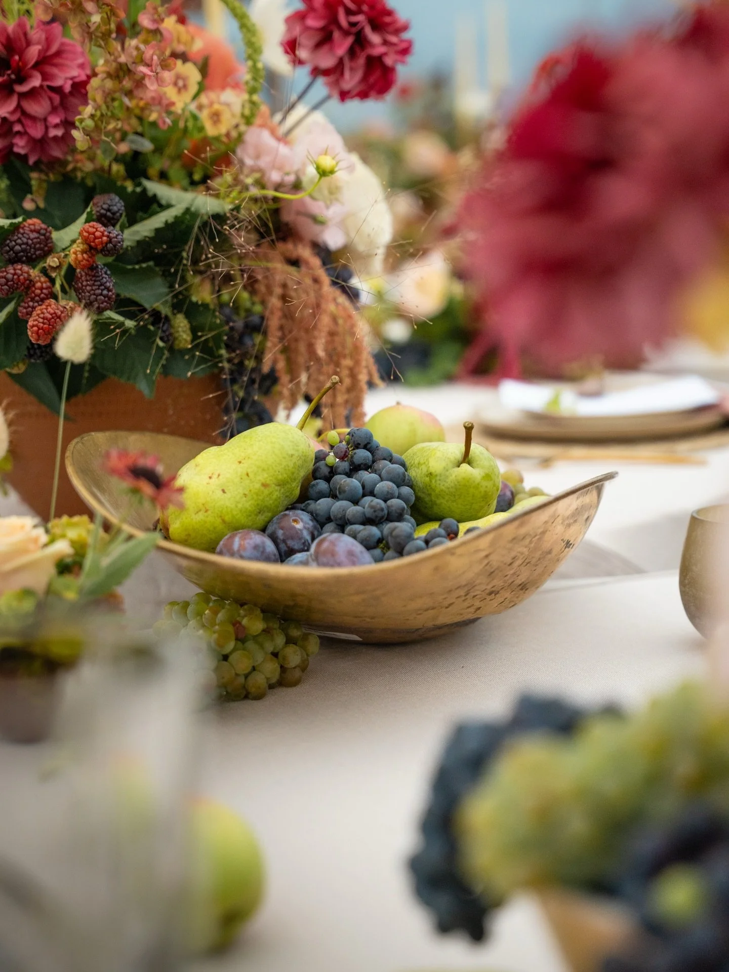 There&rsquo;s something about a table that feels abundant.

Garden florals spilling into late-summer fruit.
Brass catching the candlelight.
Layered tones, texture, movement in every direction.

This is what happens when you think beyond the bouquet.
