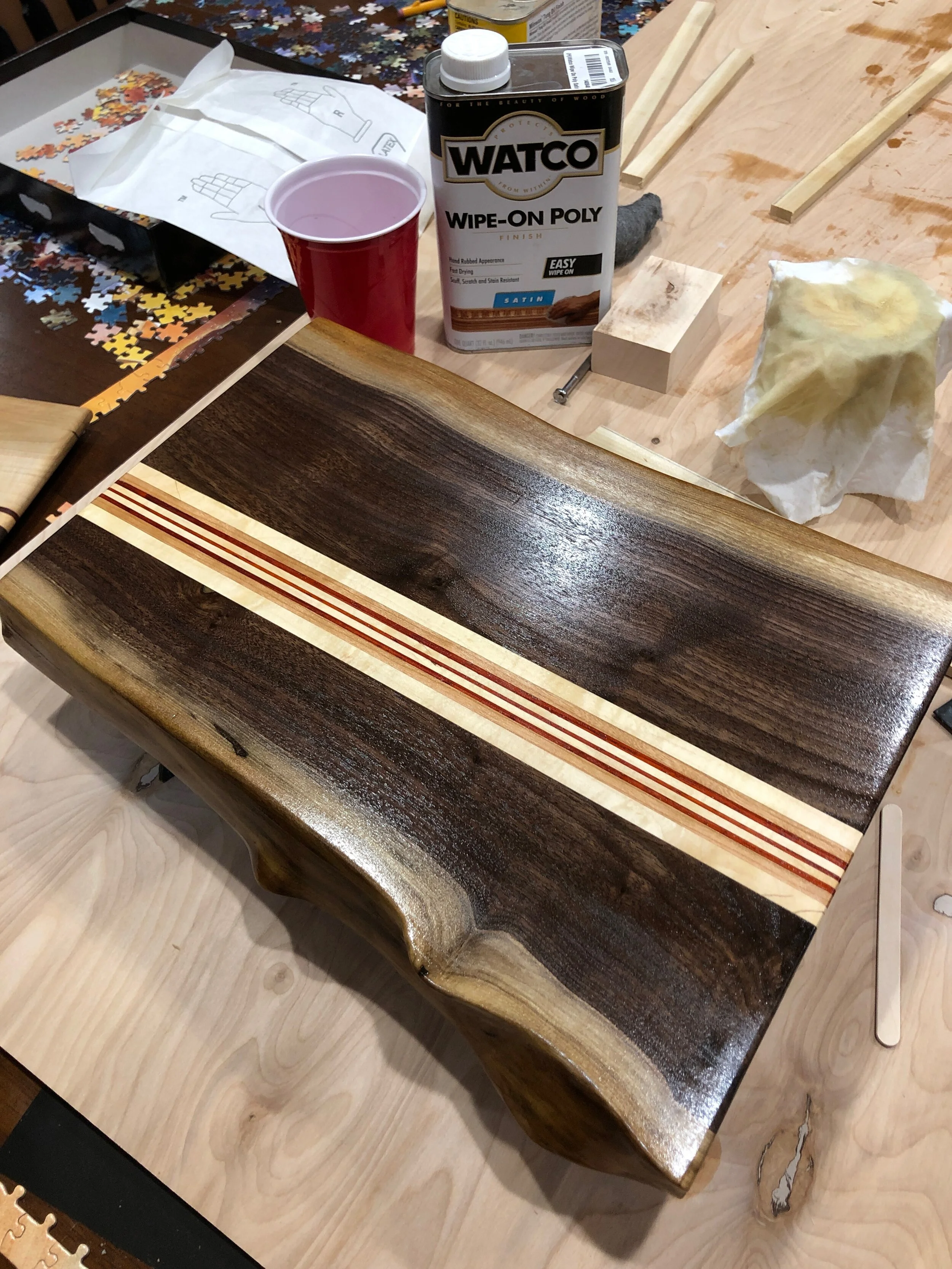 A beautiful live edge walnut cutting board with maple, padouk, stringers. 