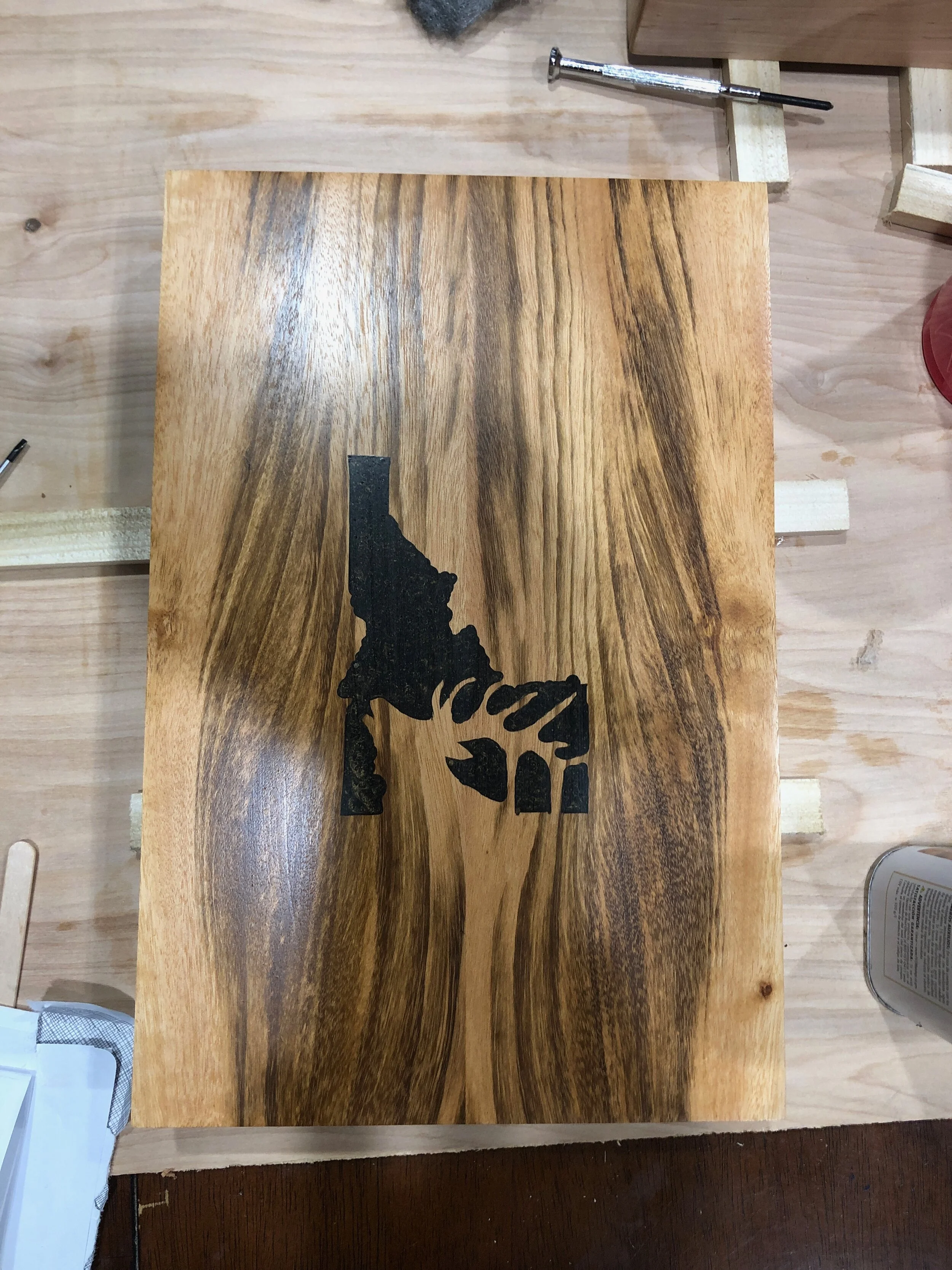 A bourbon box with and elk and Idaho cut out filled with epoxy. 