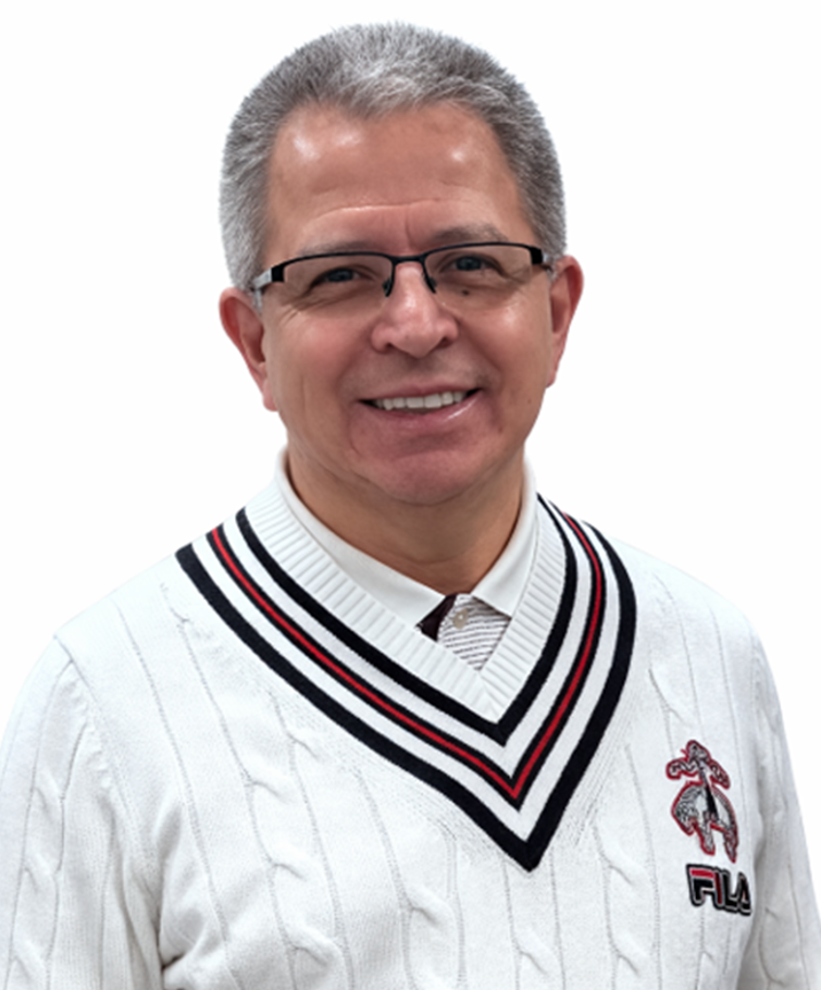 A smiling man with gray hair and glasses, wearing a white sweater with black, red, and white striped v-neck, and a white collared shirt underneath, against a white background.