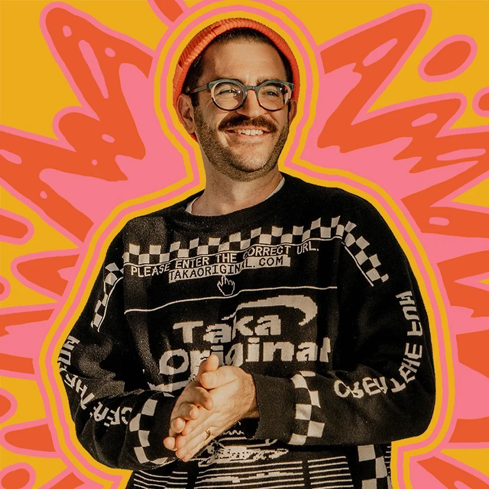 Ajax Kelly, founder of Ajax Anvil Co., a mural artist and illustrator based in Columbus, Ohio, wearing an orange beanie and glasses against a hand-drawn starburst.