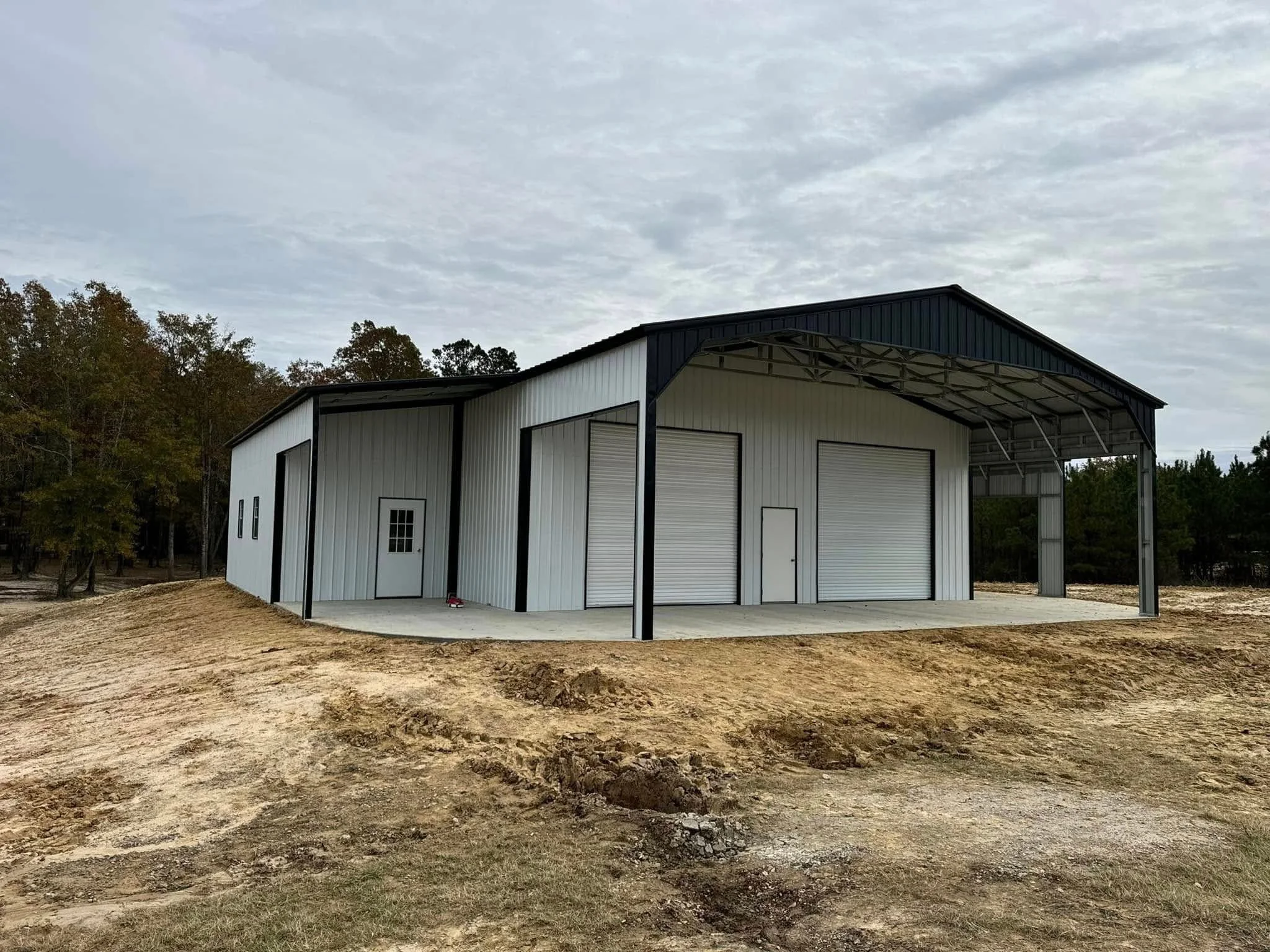 metal garage with shelter and 3 large bay roll updoors
