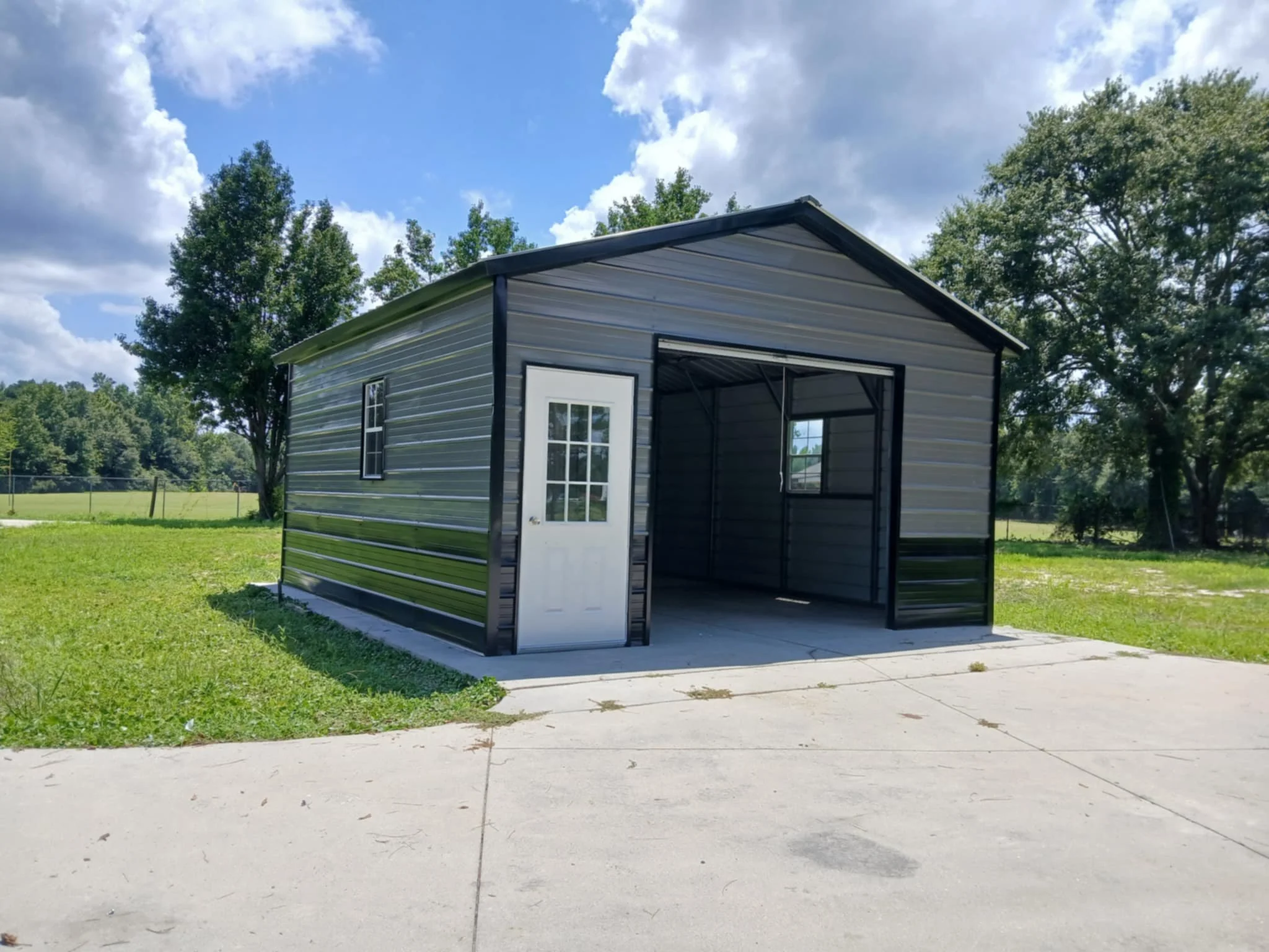 metal barn with one rollup and one entry door on front. Simple design.