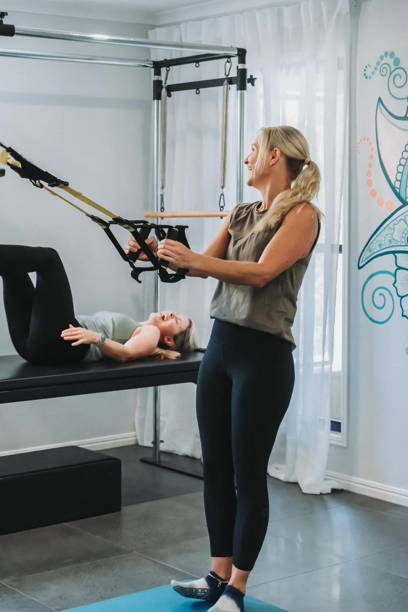 Two Mums working out side both side laughing with all there ongoing jokes