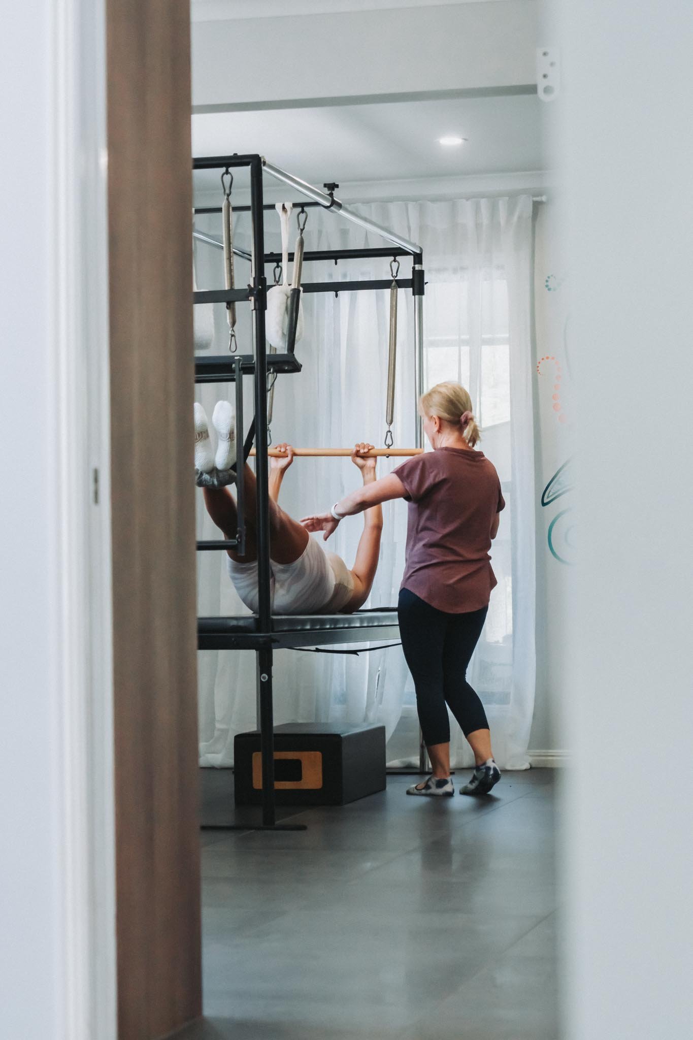 A client encouraging and supporting another client through a movement