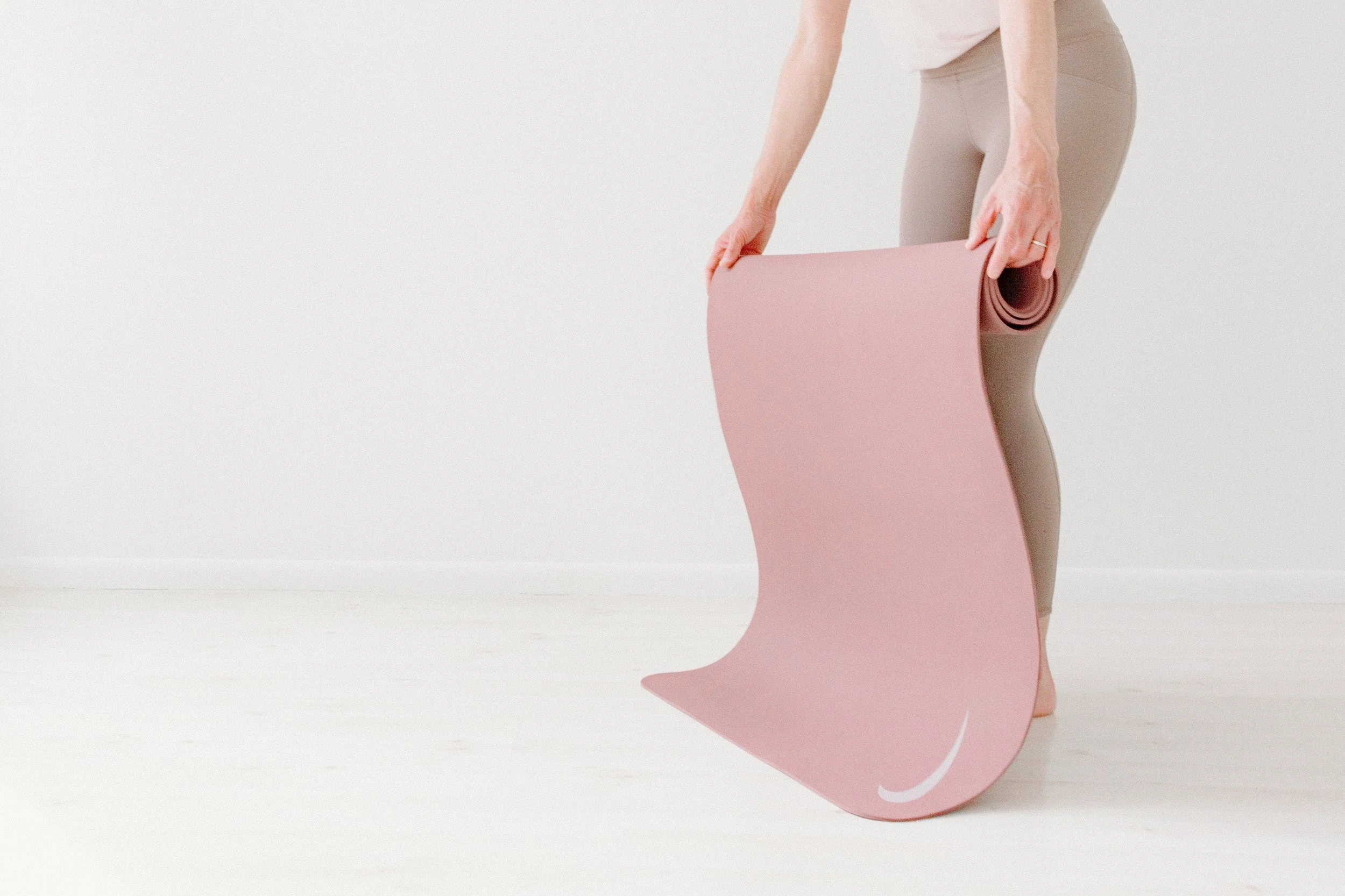 woman placing a mat on the ground 