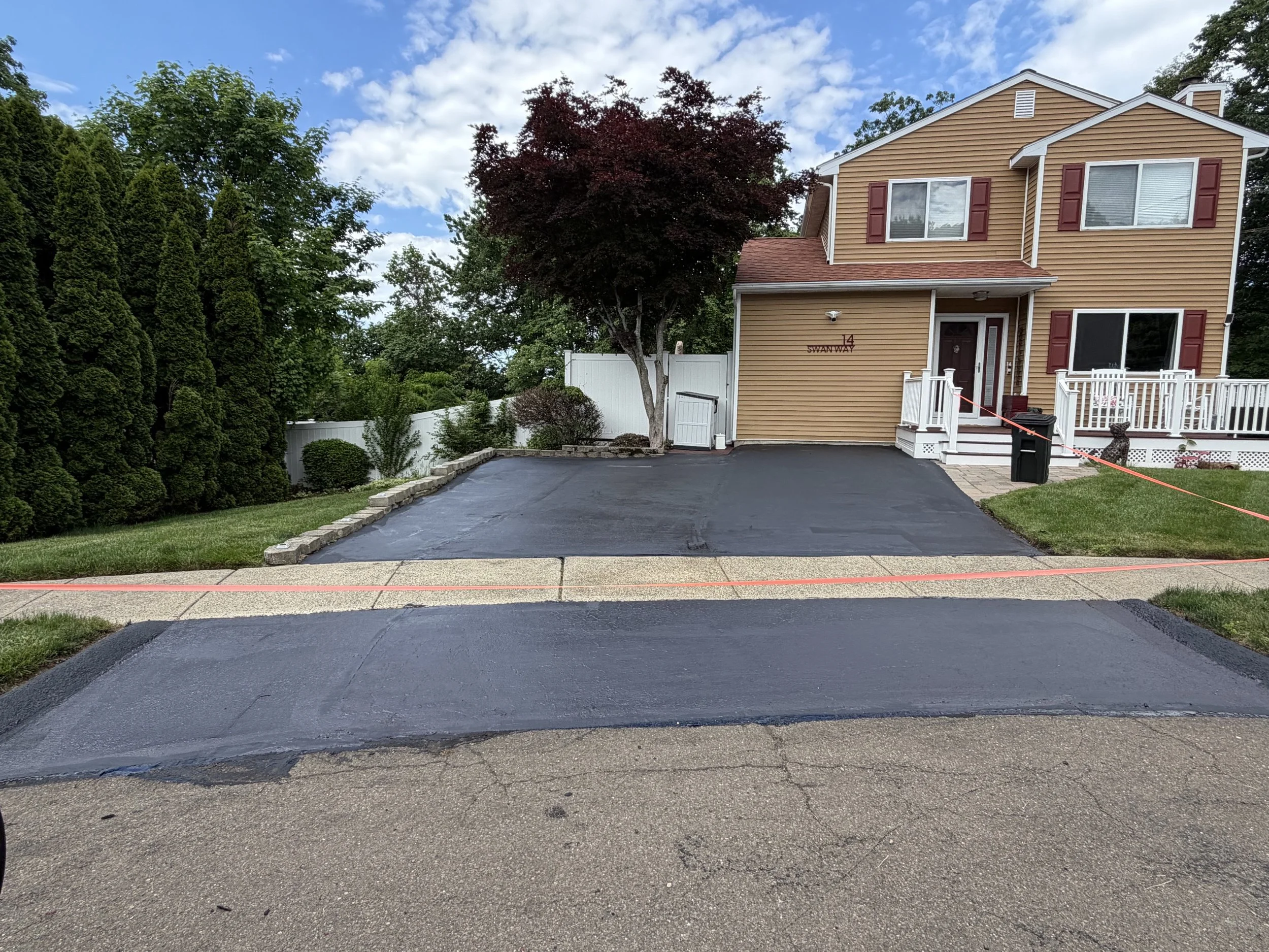 This homeowner in East Haven wanted to restore the look of their asphalt driveway and protect it from wear and tear with a fresh layer of sealcoating in May 2026.