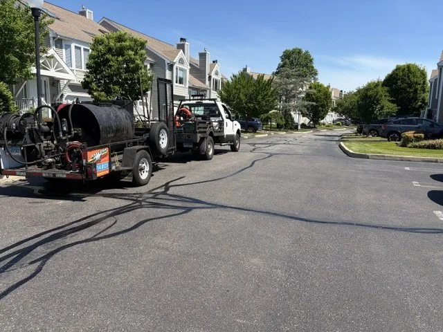 Asphalt crack filling done at a 70,000-square-foot apartment complex in Milford on May 31, 2026. 