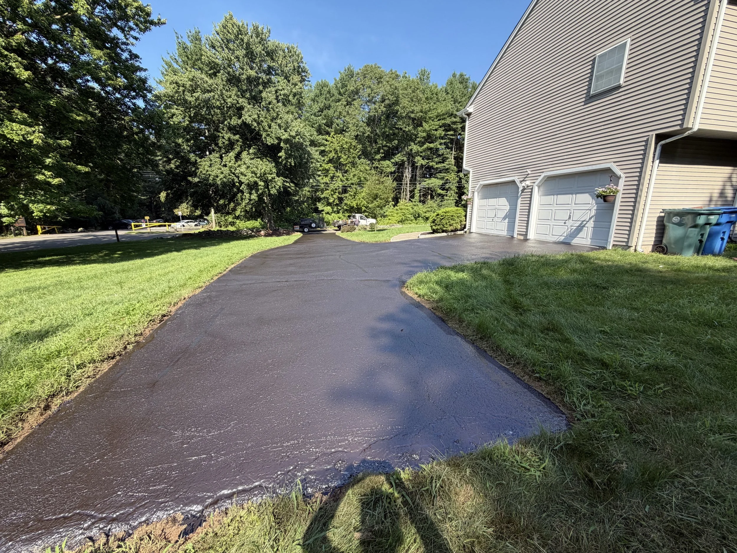 A driveway has a new shine to it after an August 2026 sealcoating in Hamden, CT.