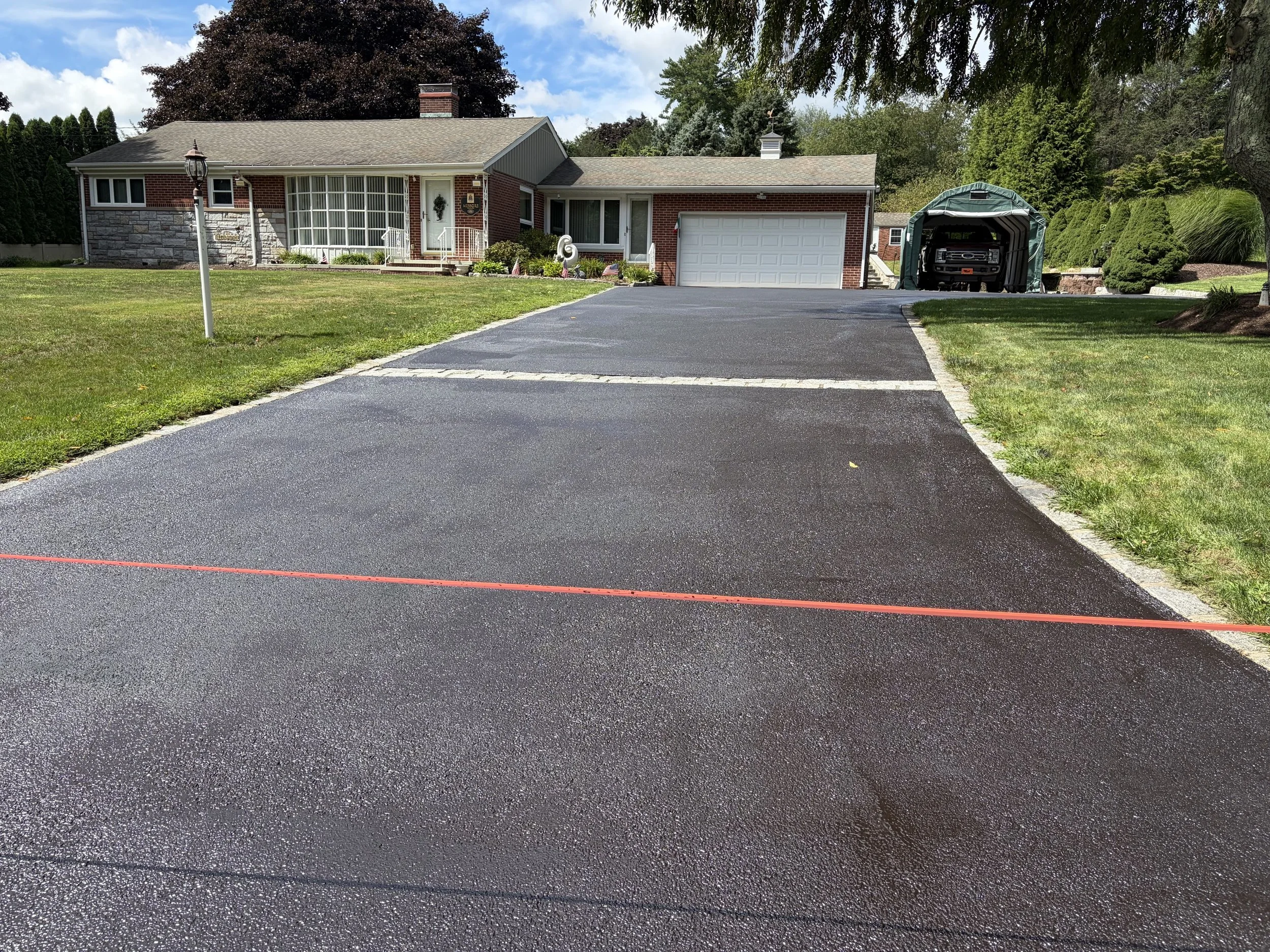 A fresh look of sealcoating for this driveway in Orange in August 2026
