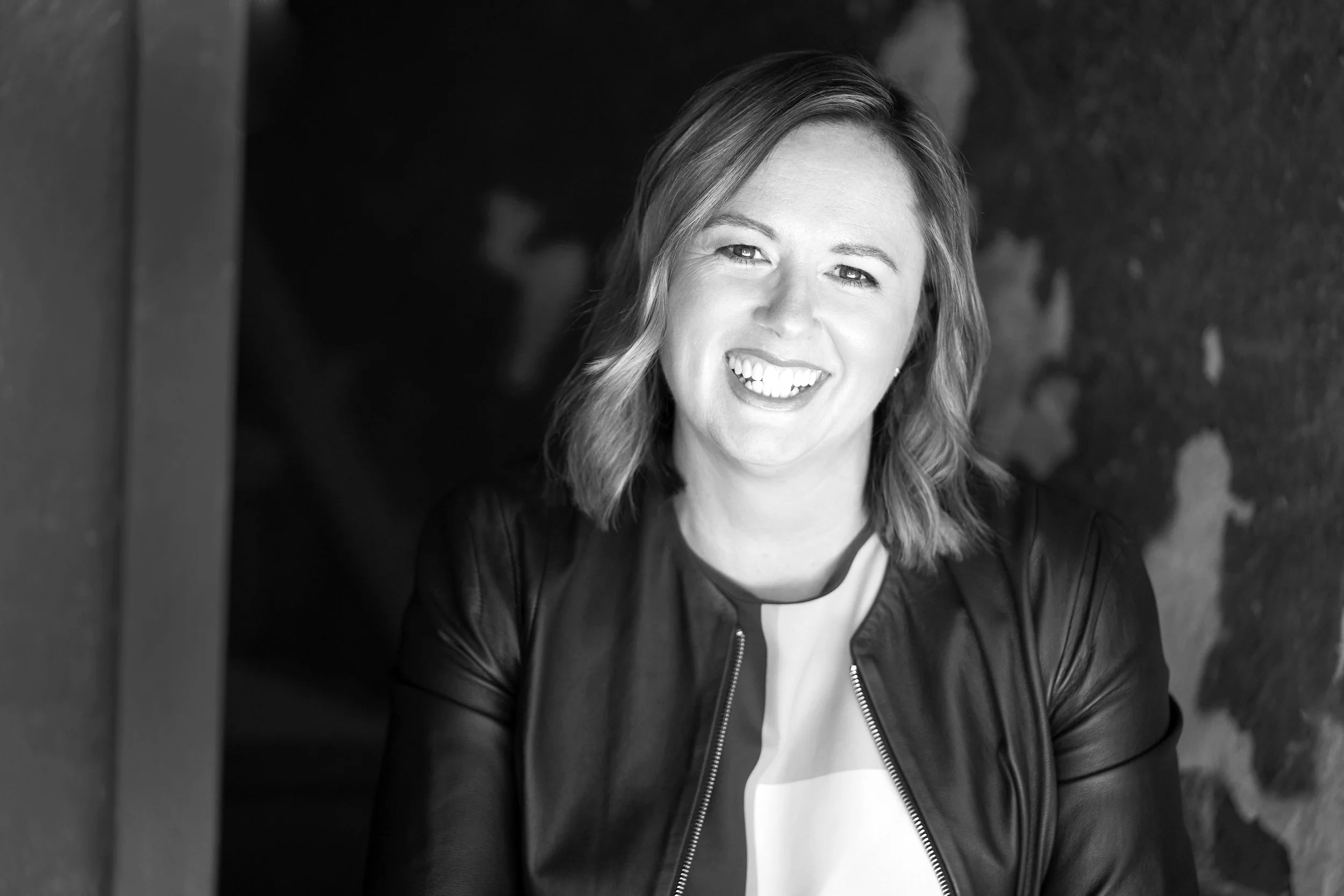 Tammy smiling warmly in black & white filter
