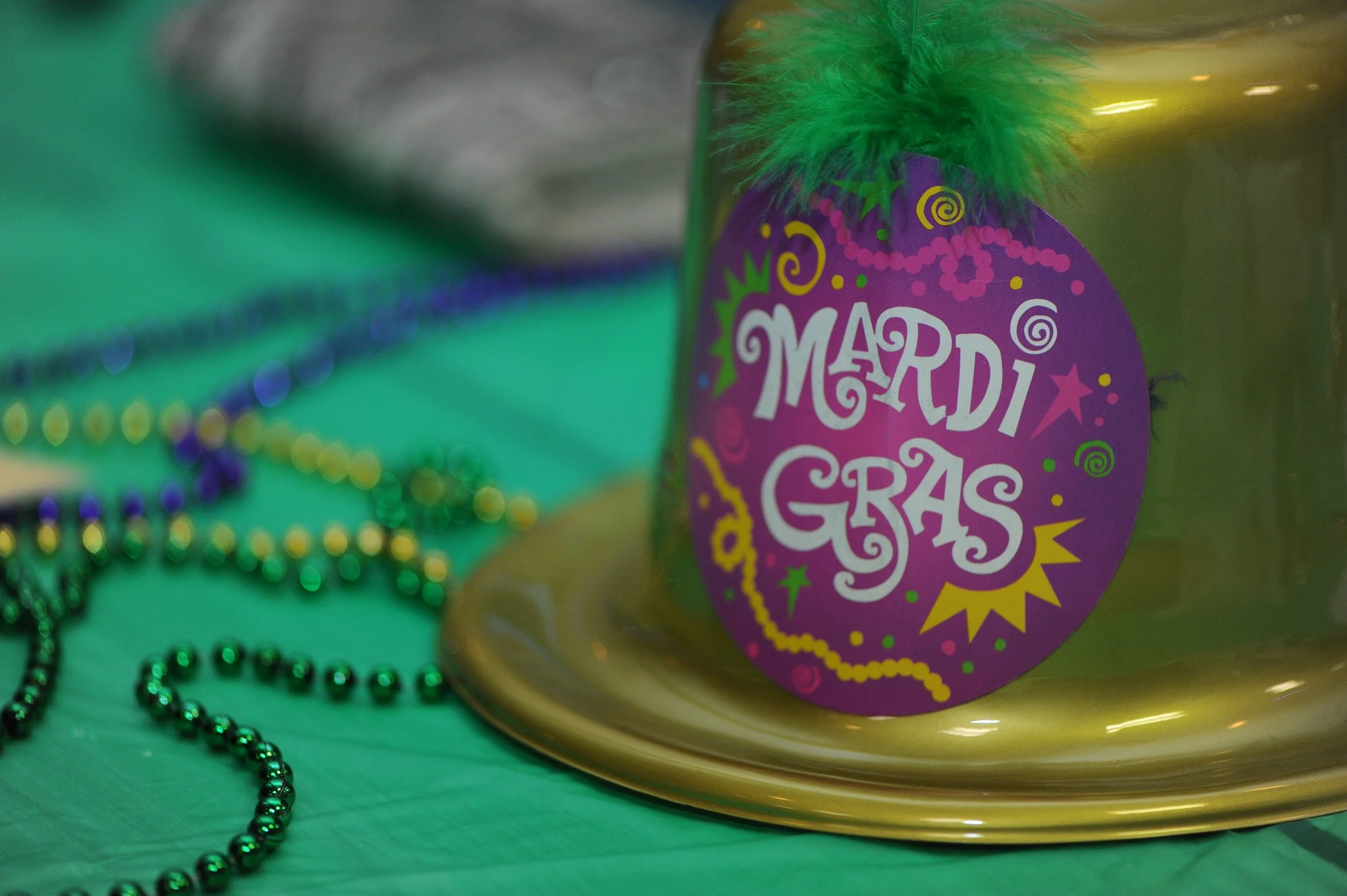 Mardi Gras Hat and beads on table