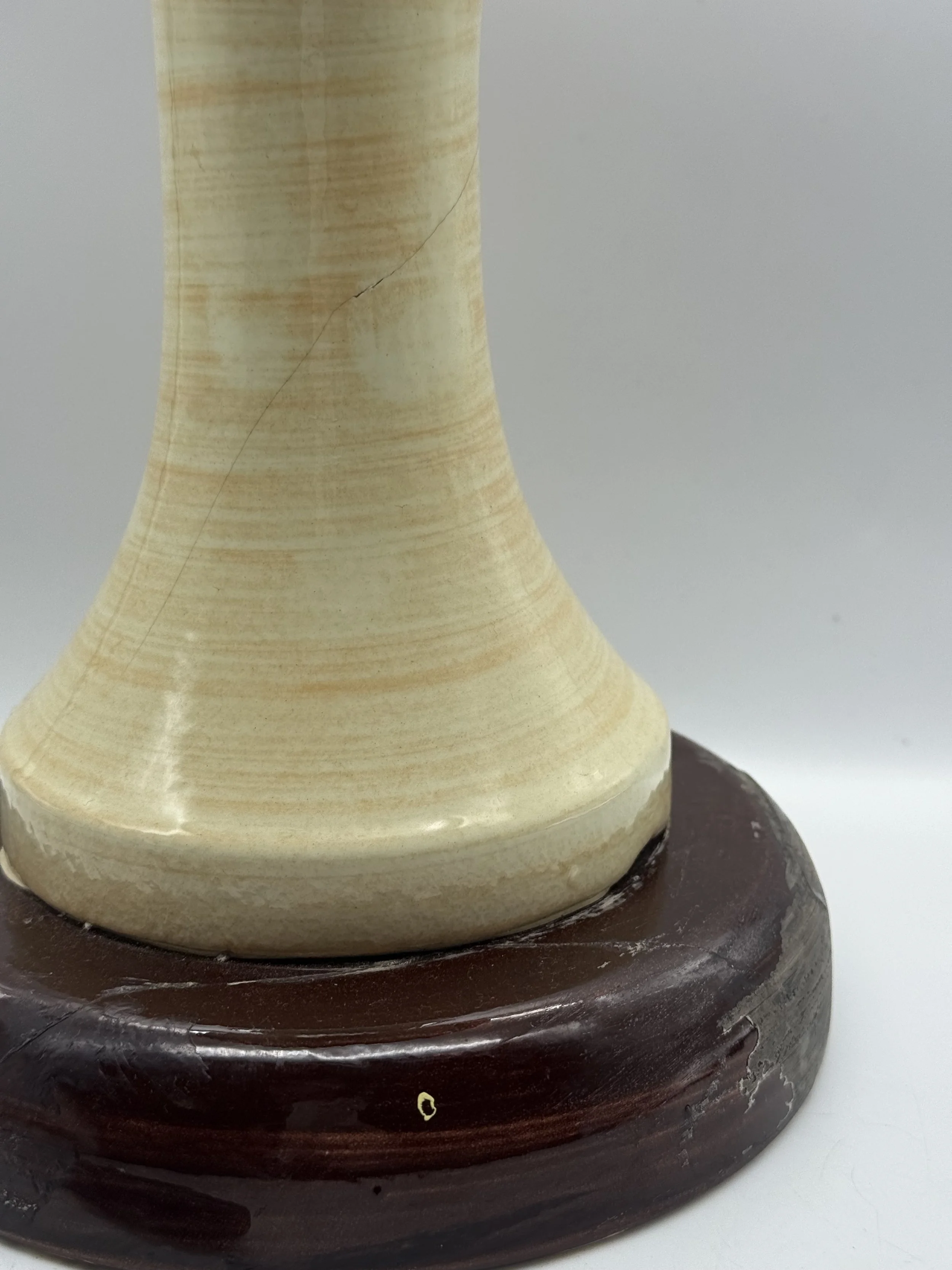 Detail of the Stangl wig stand's neck and wood base