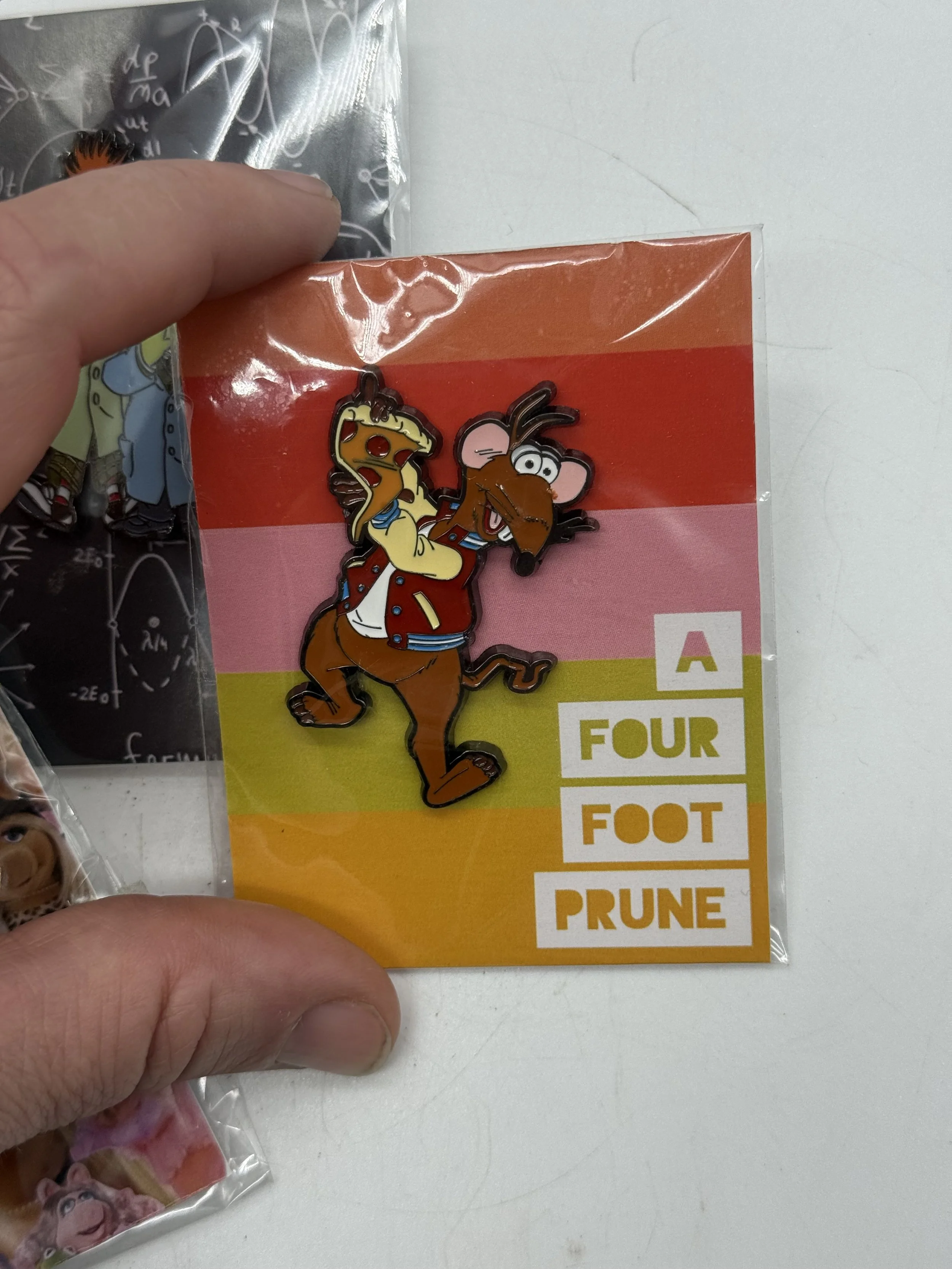 Muppet enamel pin on an A Four Foot Prune backing card held in hand