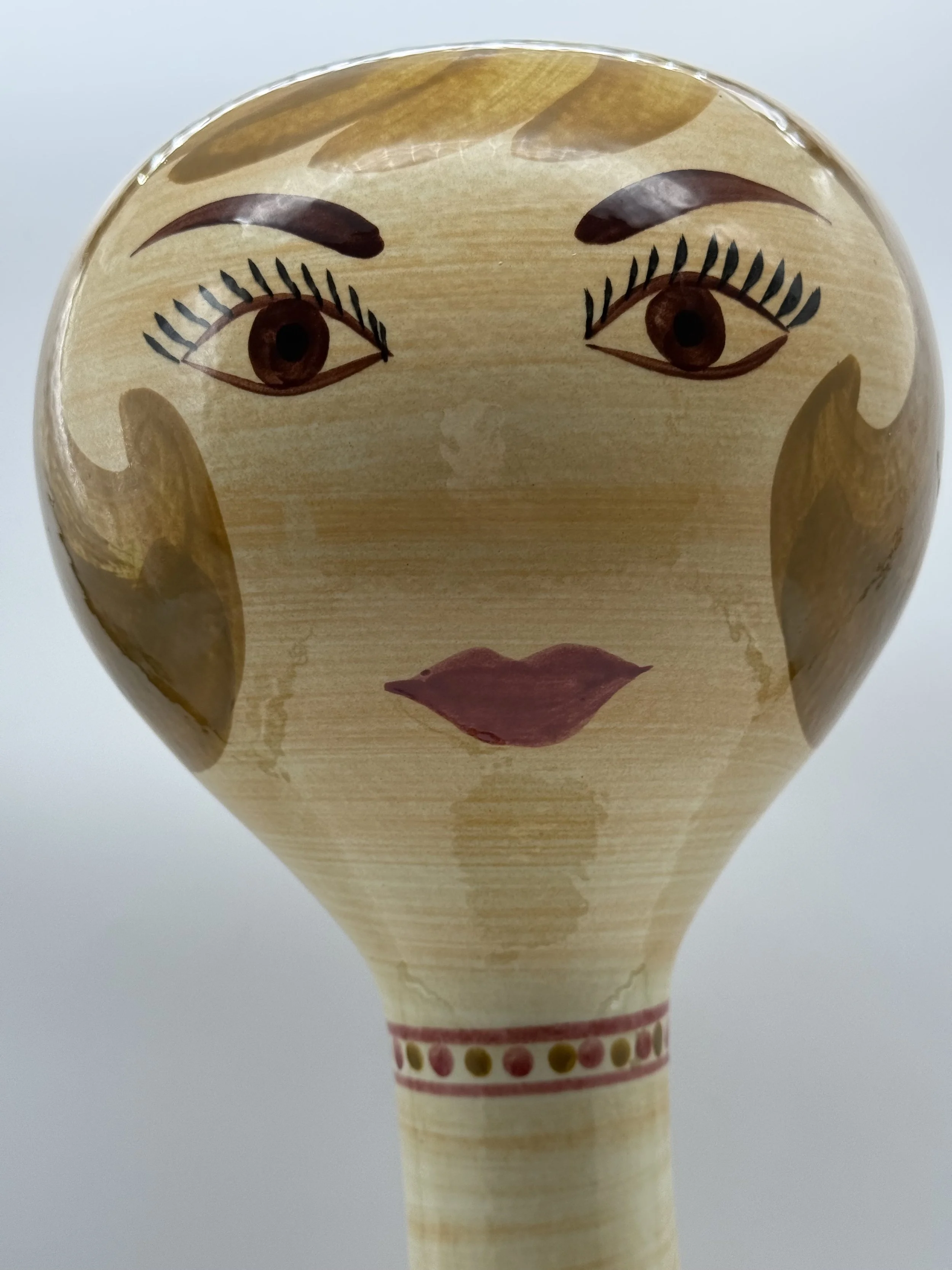 Close-up of the painted face on the Stangl wig stand