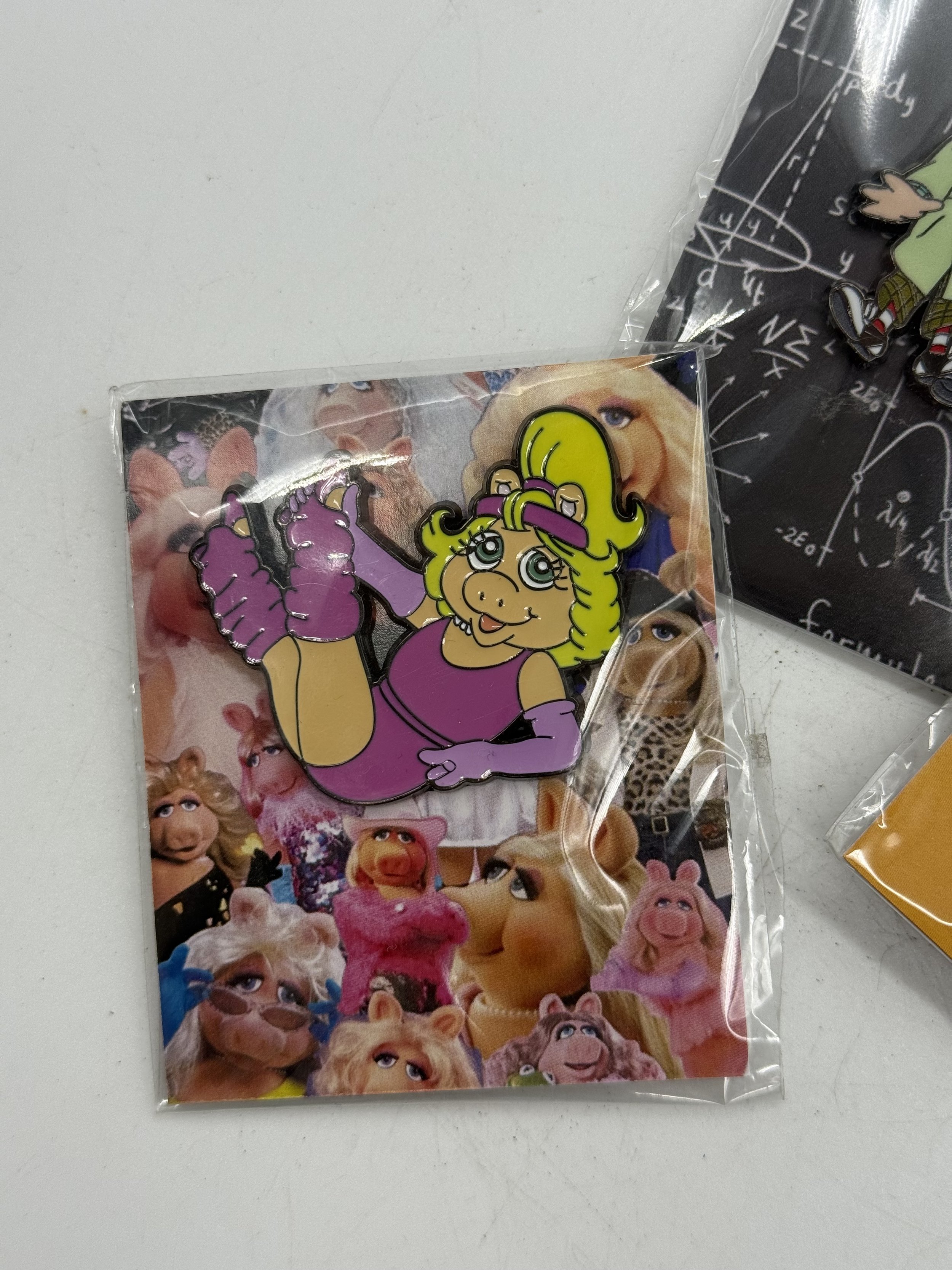 Close-up of two of the Muppet enamel pins in their packaging