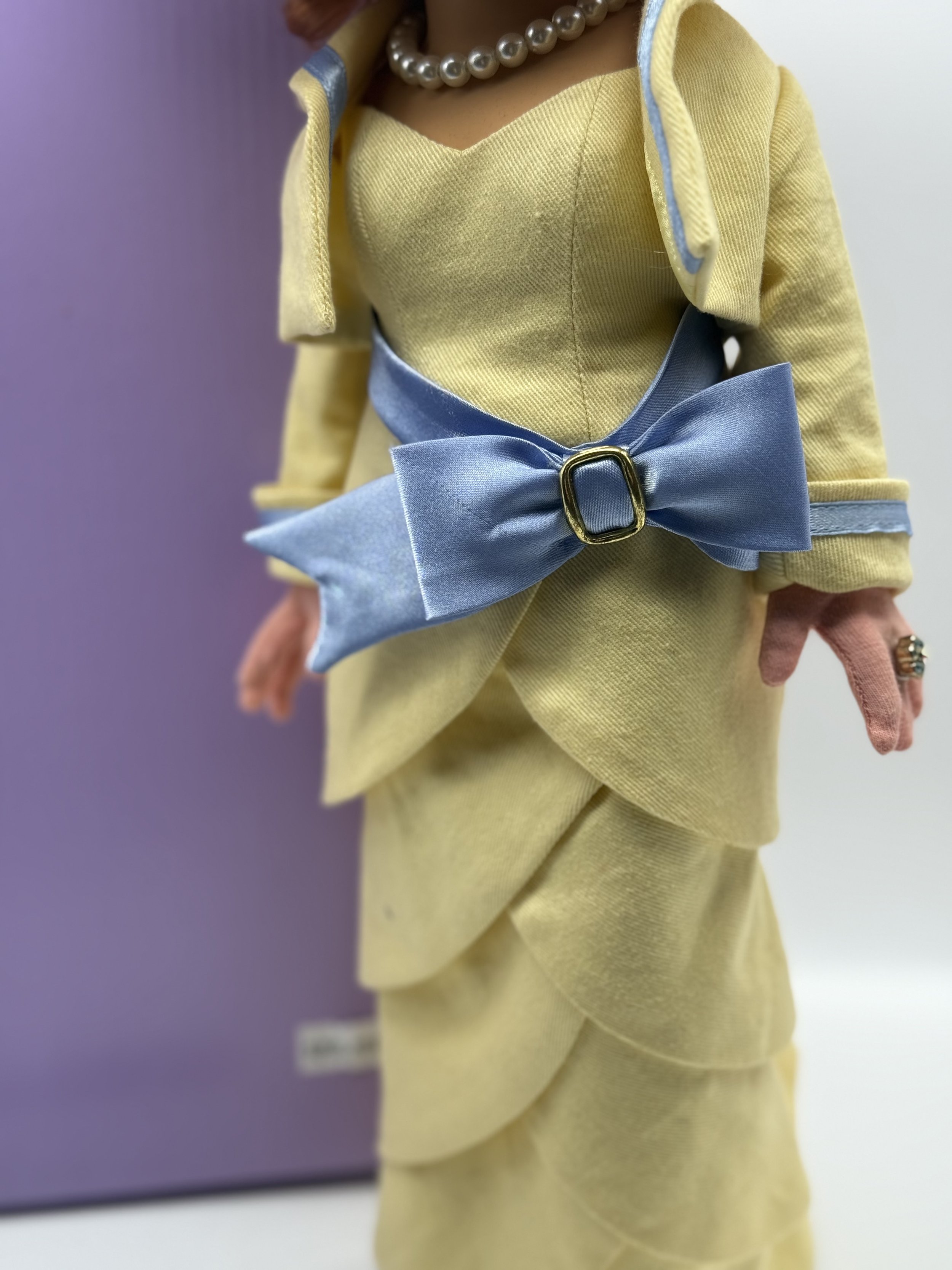 Detail of the My Fair Piggy gown with its blue satin bow