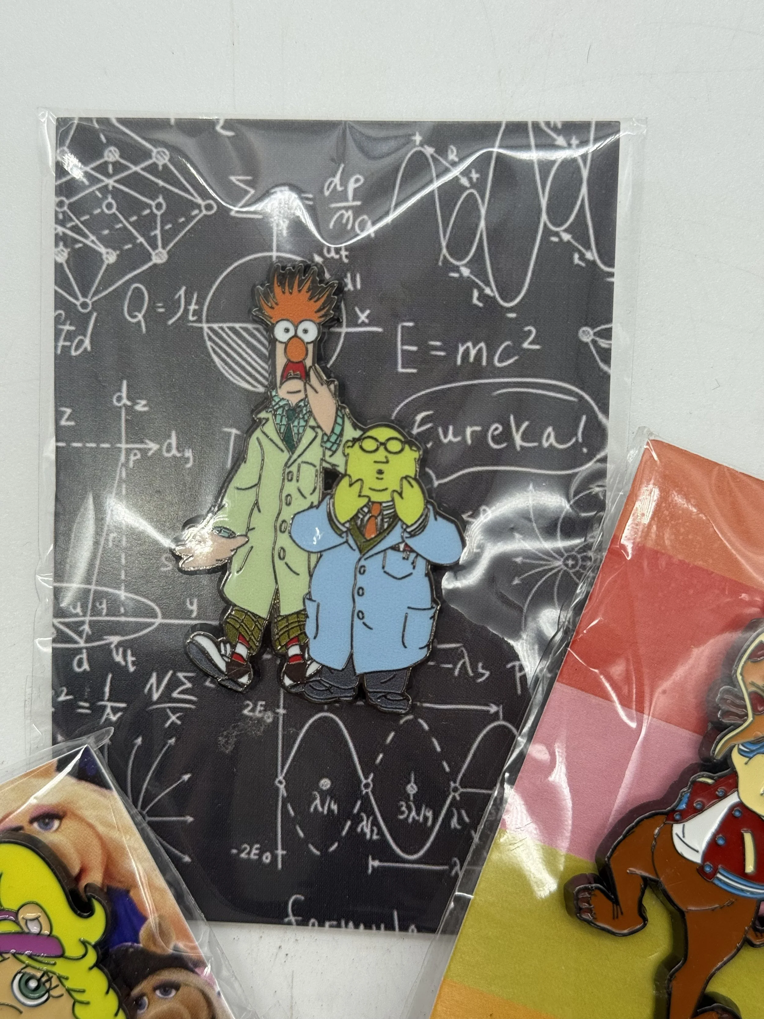 Muppet enamel pin on its chalkboard-style backing card