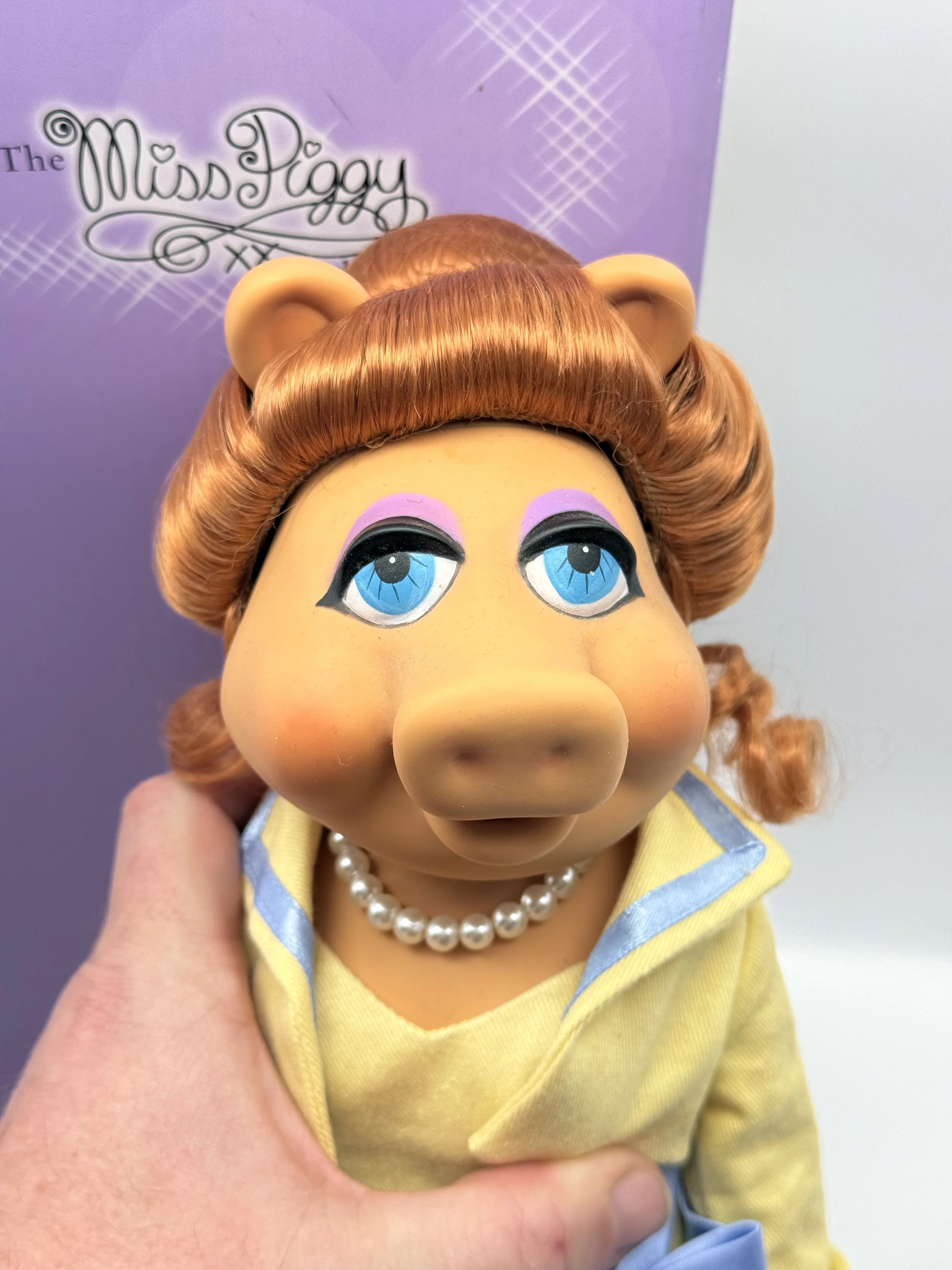 Tonner Miss Piggy doll held in hand without her hat
