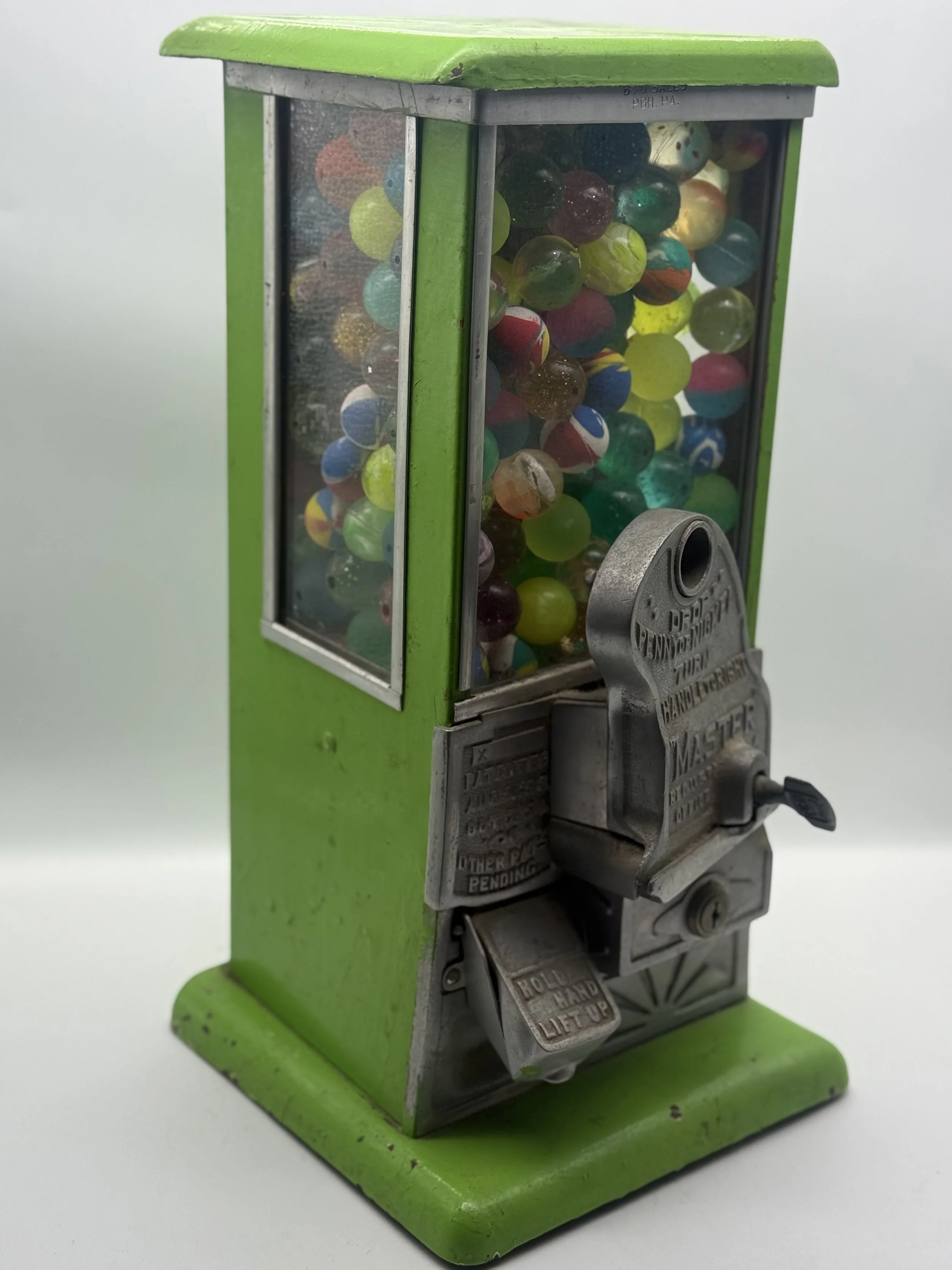 Side view of the green 1930s Master gumball machine