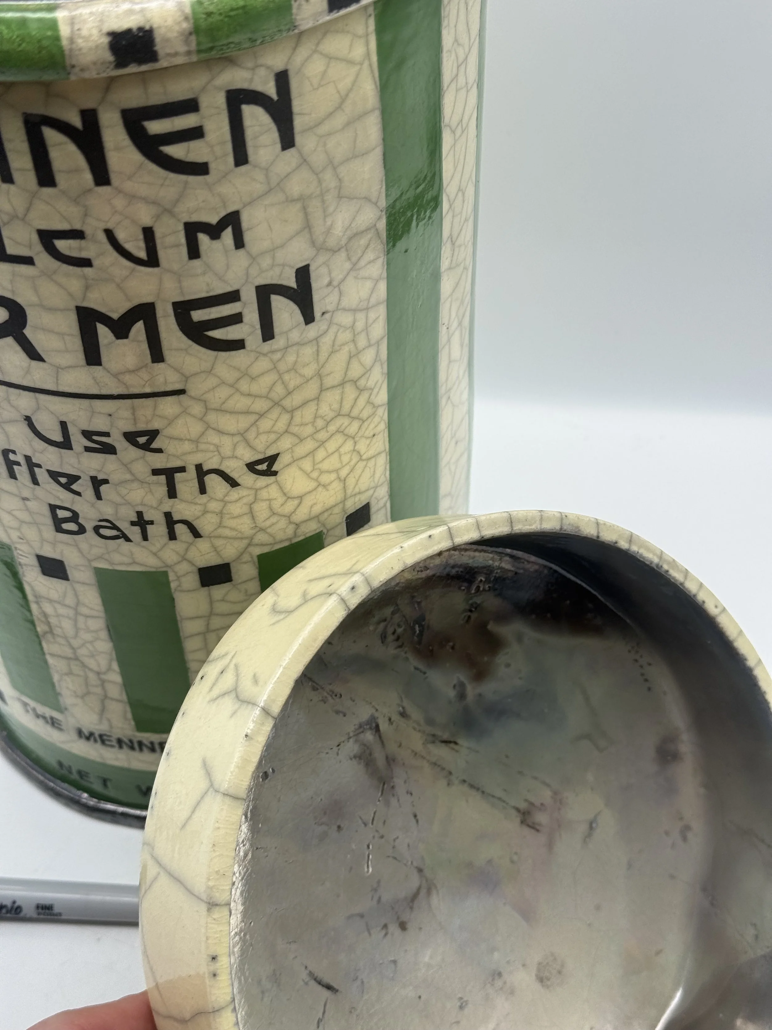 Inside of the lid on the Karen Shapiro raku Mennen talcum piece