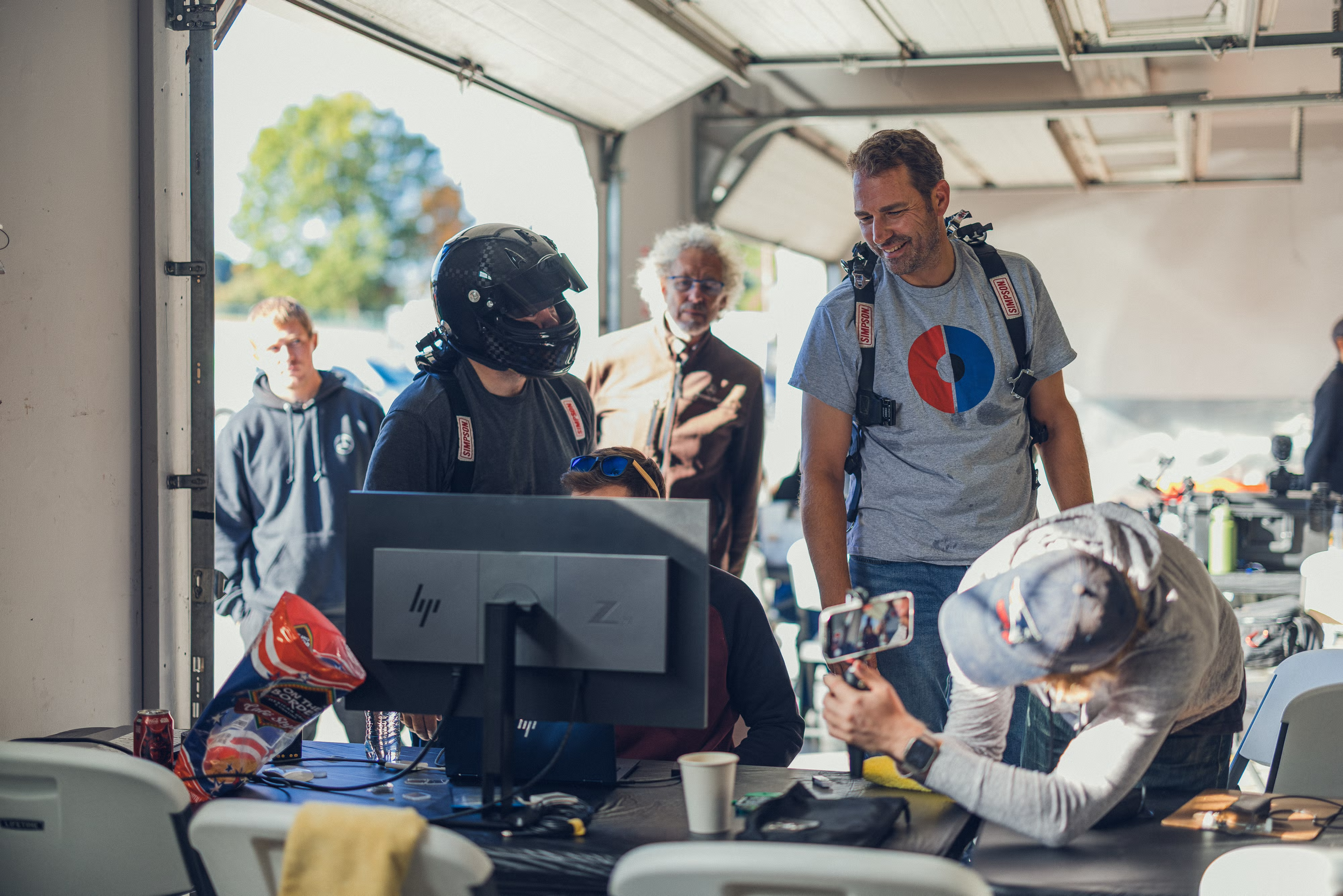 Car and Driver team analyzing data in garage bay