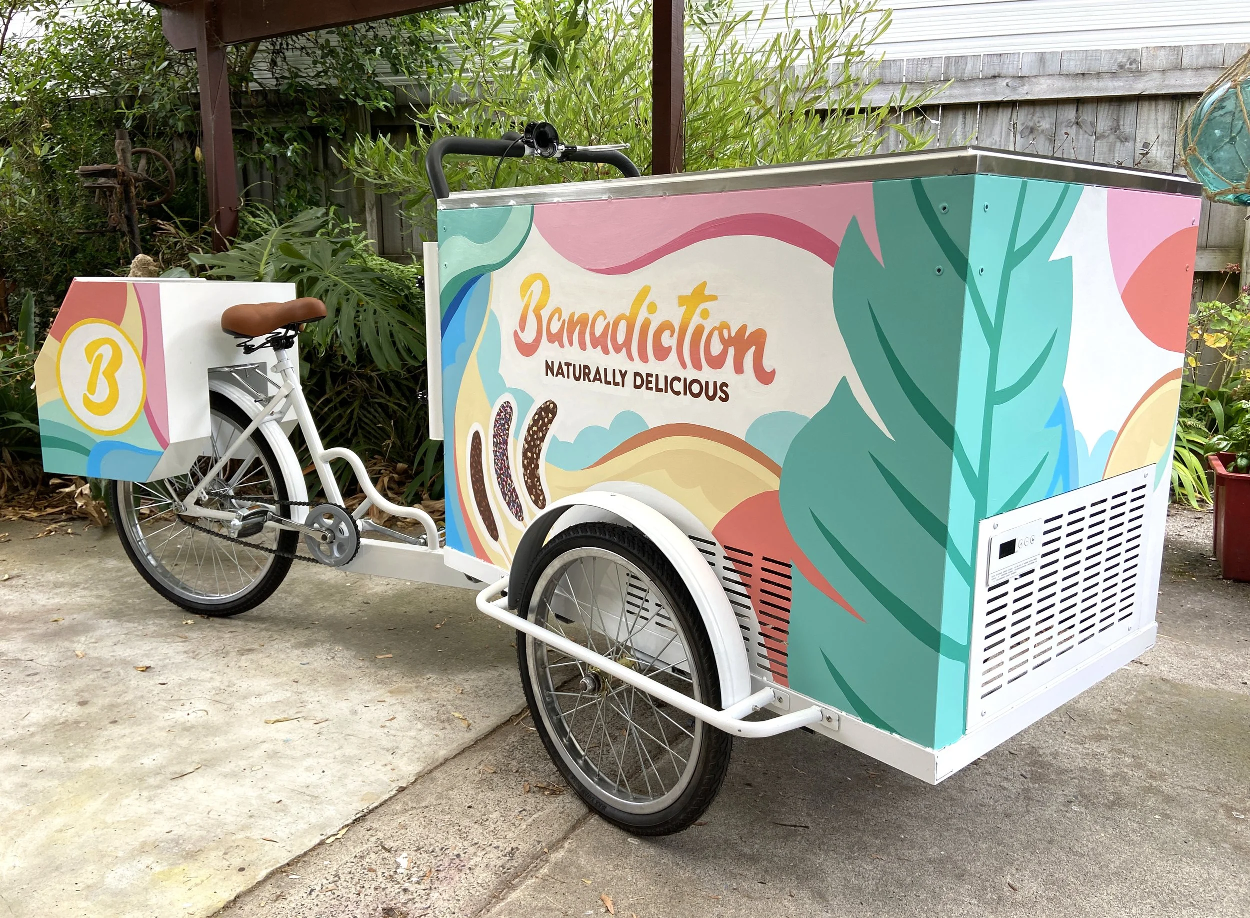  Banadiction frozen banana trike 

 A mural on three wheels! This piece was created for a mobile dipped frozen banana business. The pastel palette and flowing shapes were designed to evoke dreamy summer days and a sense of playful warmth.
 