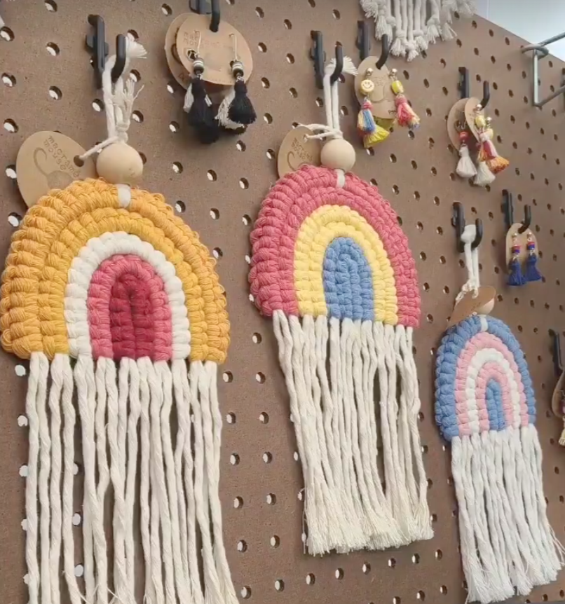macrame rainbow keychains in the lesbian, pan, and trans flag colors