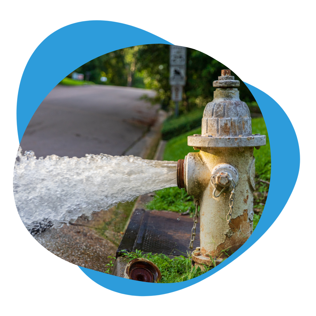 Fire hydrant discharging water onto a street, representing hydrant water extraction and non-revenue water in urban distribution networks.